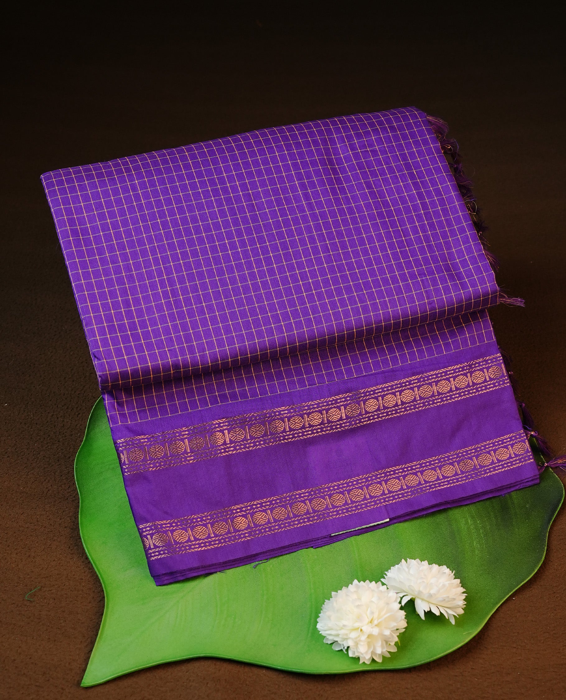 Indigo colour kalyani cotton saree featuring gold zari check pattern on body, complemented by Self colour with Antique zari border, paired with matching blouse piece.