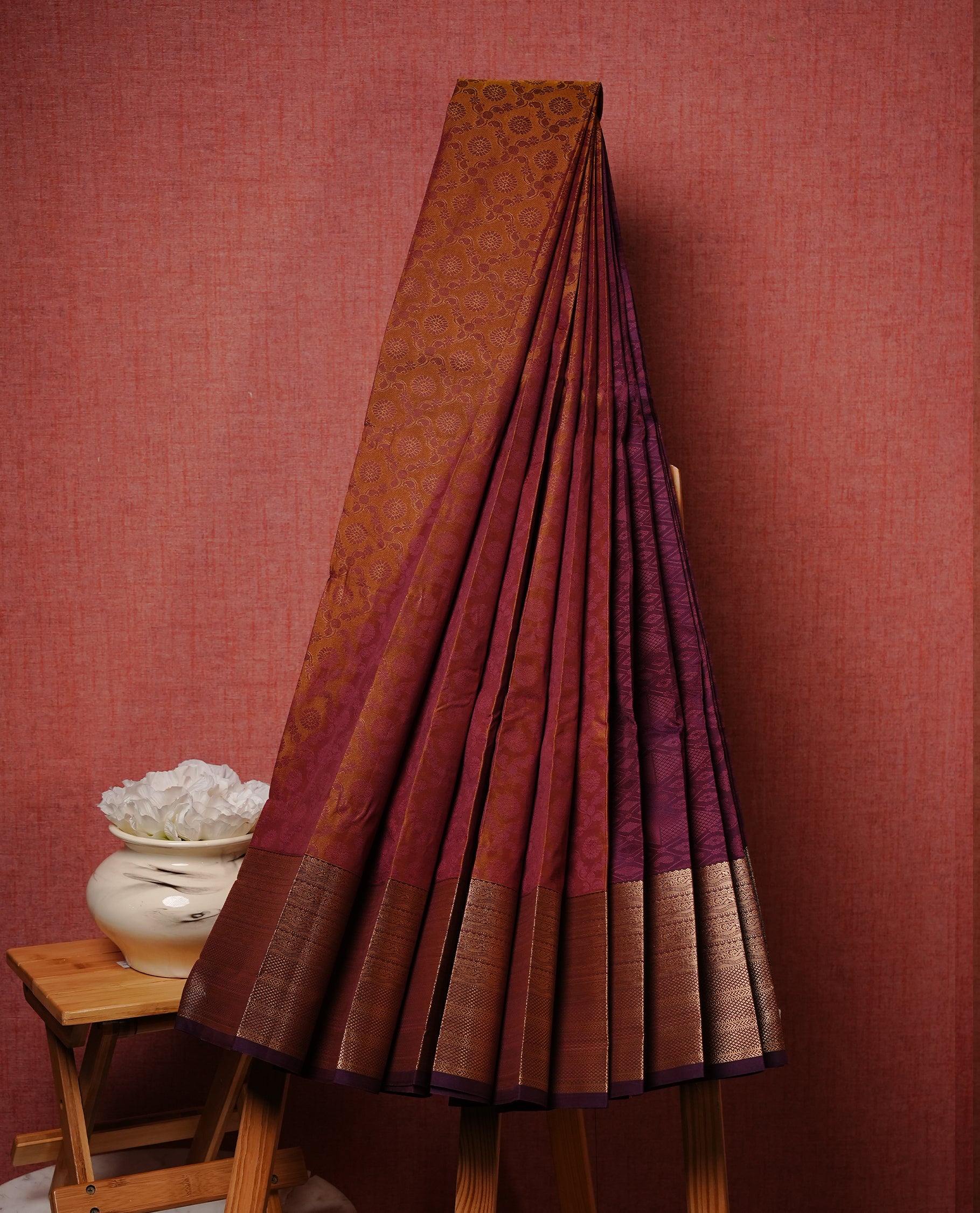 Maroon & gold colour Semi silk saree Featuring self colour zari motifs on body, complemented by contrast burgundy colour with gold zari border, paired with matching blouse piece.