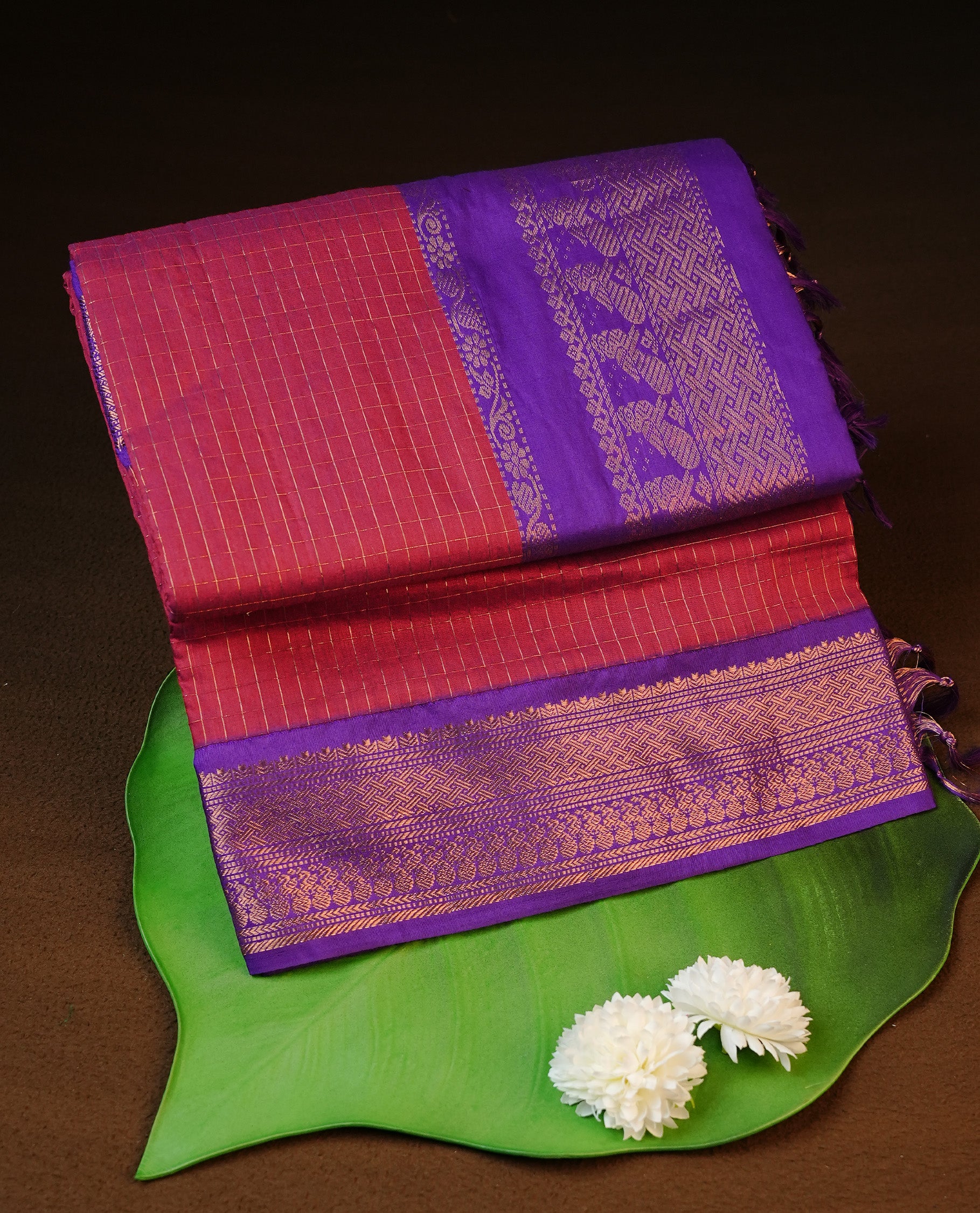 Maroon colour kalyani cotton saree featuring gold zari check pattern on body, complemented by Violet colour with Antique zari border, paired with matching blouse piece.