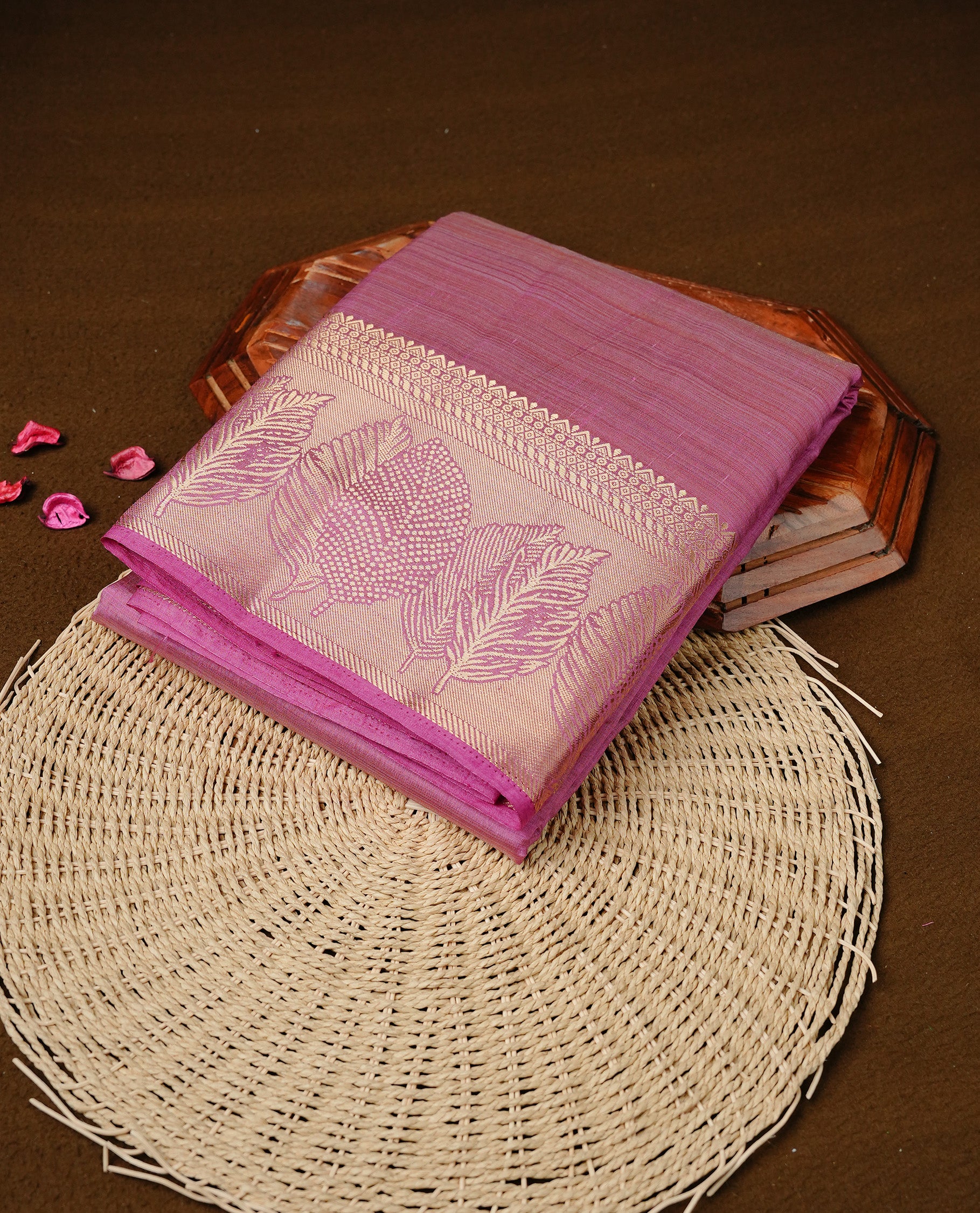 Pink colour semi tussar silk saree featuring an elegant plain body with traditional gold zari detailed border for a refined look. Comes paired with a matching blouse piece.