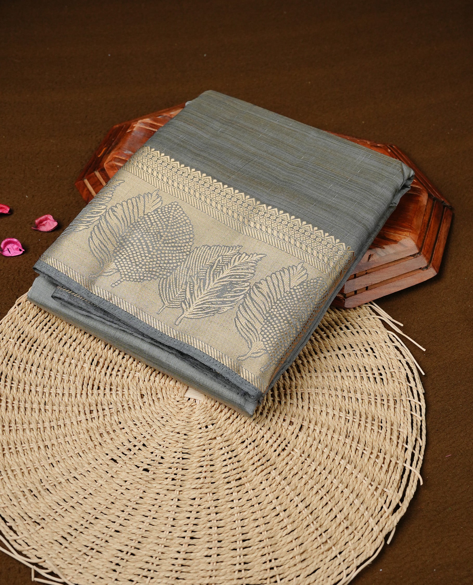 Gray colour semi tussar silk saree featuring an elegant plain body with traditional gold zari detailed border for a refined look. Comes paired with a matching blouse piece.