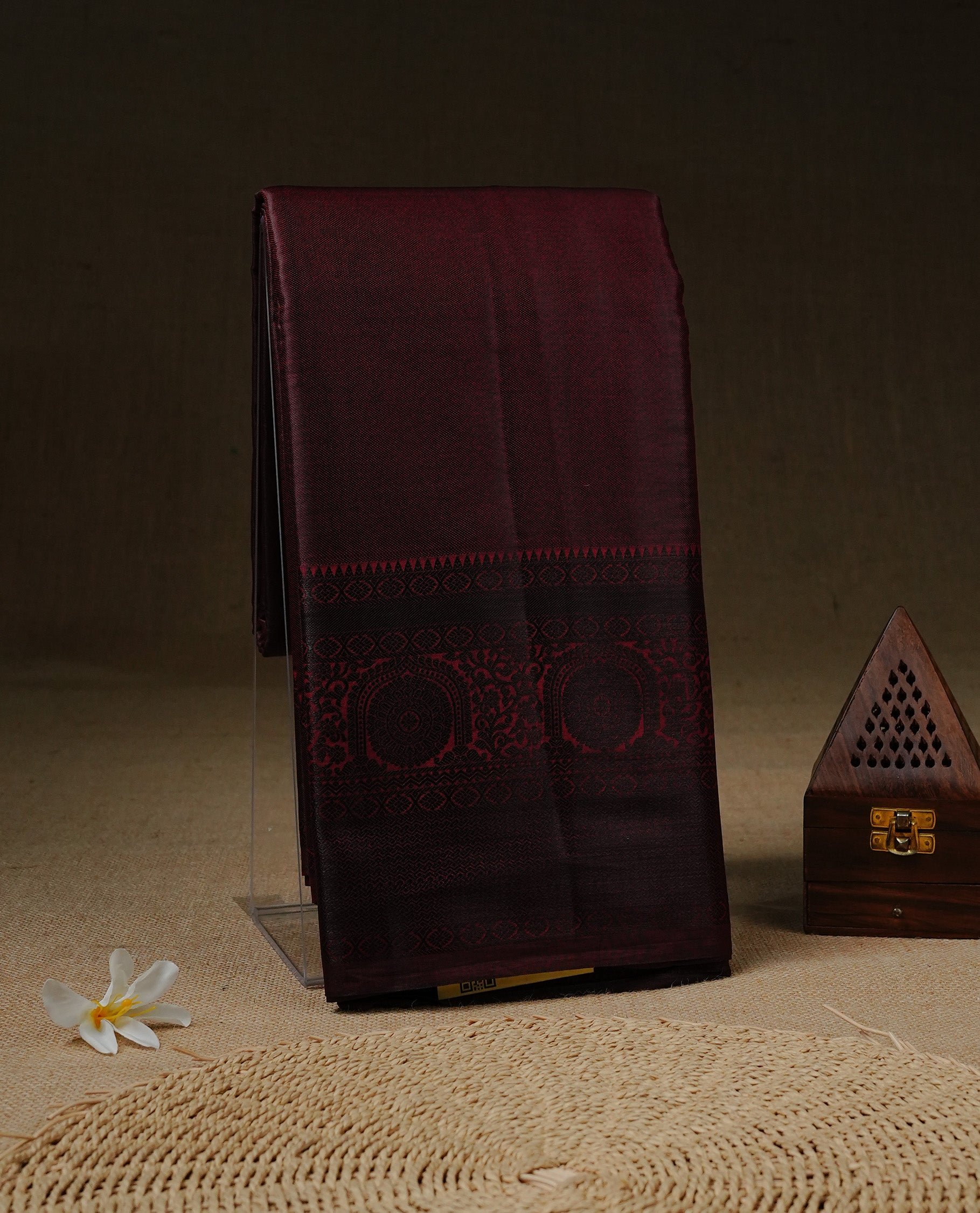 Dark Chocolate brown Tissue silk saree featuring Elgant Plain body, enhance with black traditional zari border, paired with matching blouse piece.