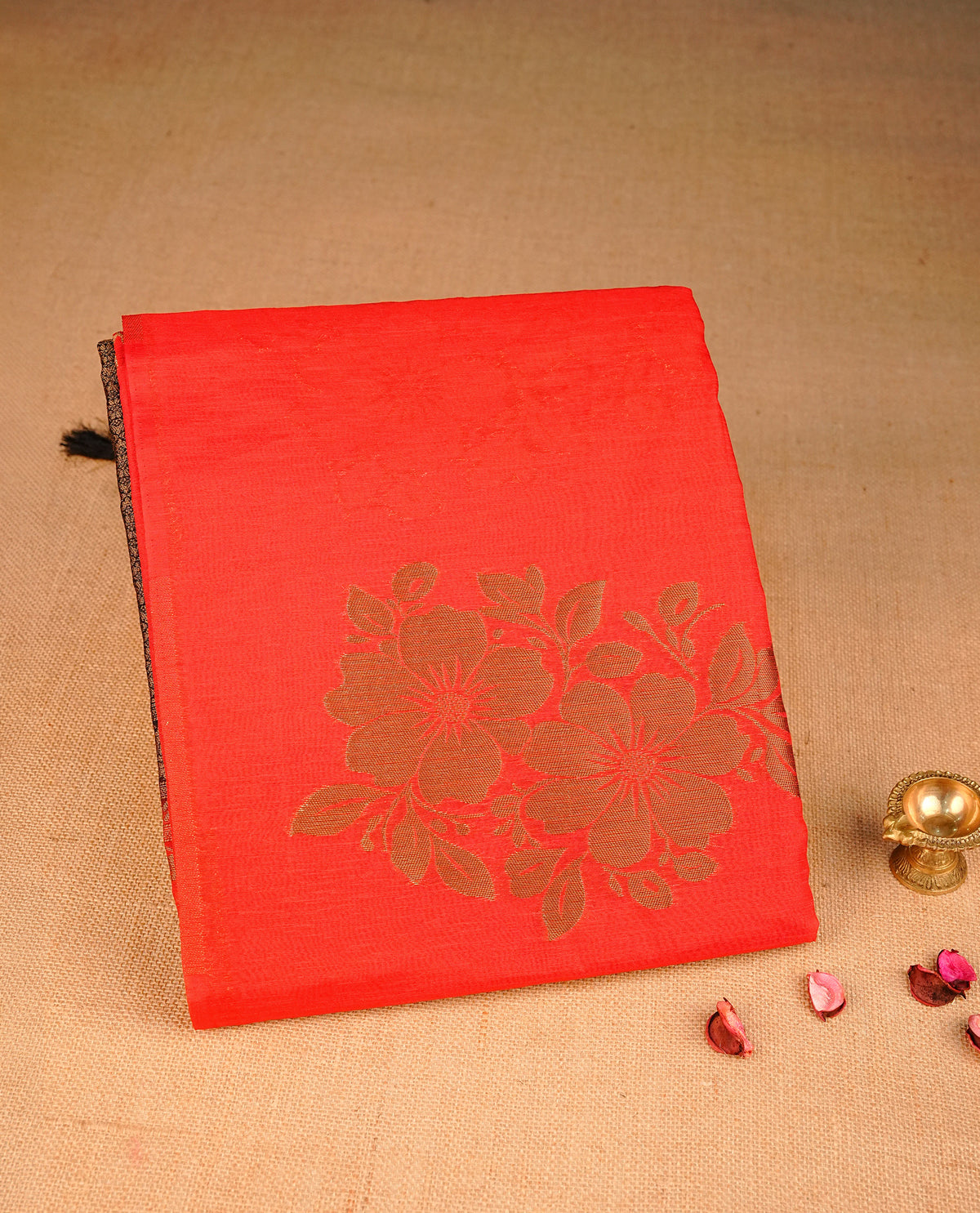 Red colour semi linen saree with elegant gold zari floral motifs across the body, complemented by a grand gold zari work with contrast pallu and a borderless design, paired with a matching blouse piece.