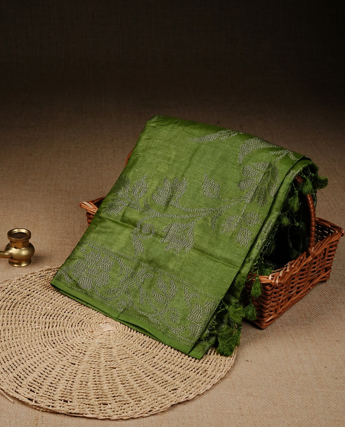Olive green colour banaras saree featuring Antique zari kodi pattern on body, complemented by Zari pattern on self colour border, comes with matching blouse piece.