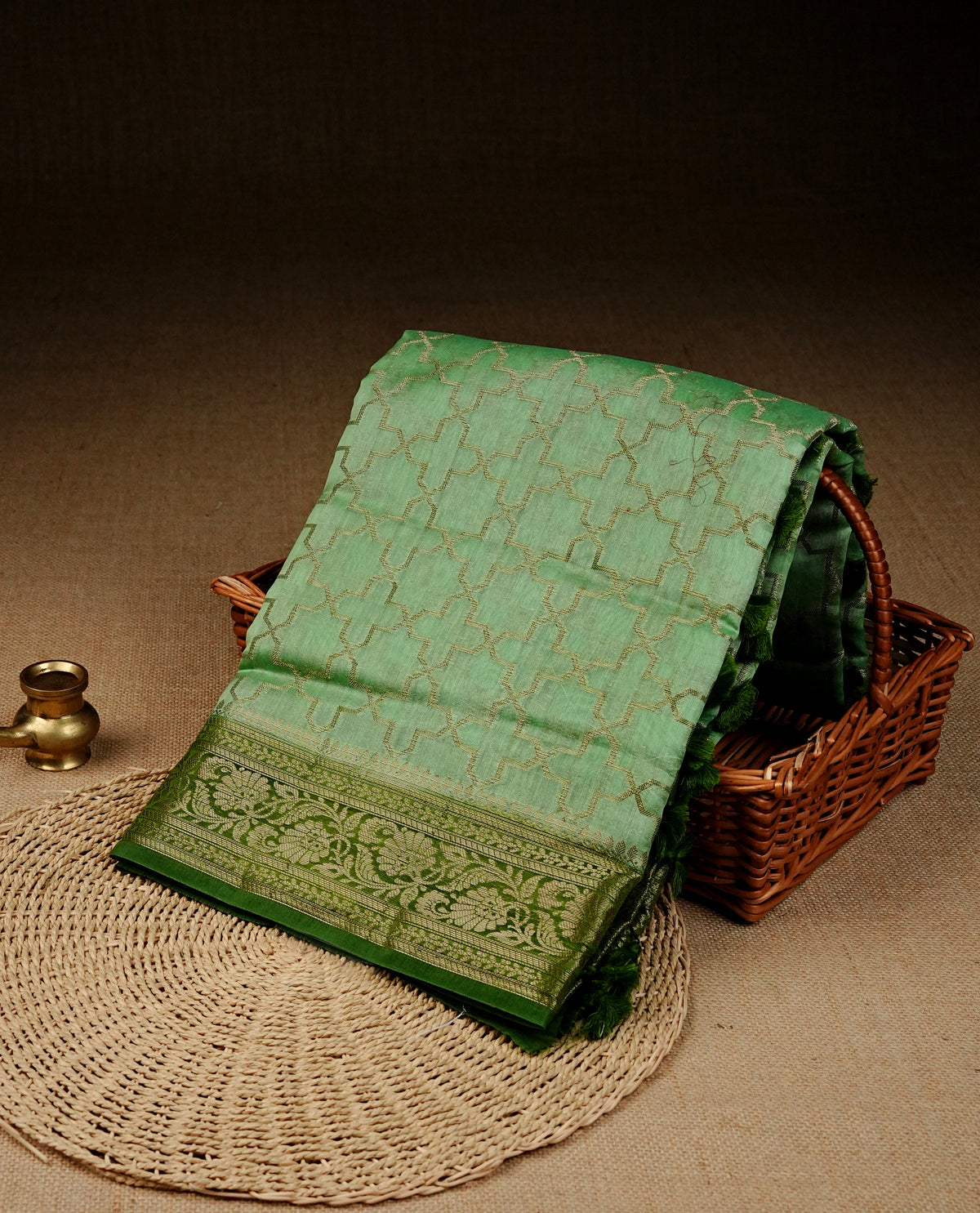 Light green colour Banaras silk saree featuring gold zari Geometric pattern on body, complemented by contrast green colour with zari border, comes with matching blouse piece.