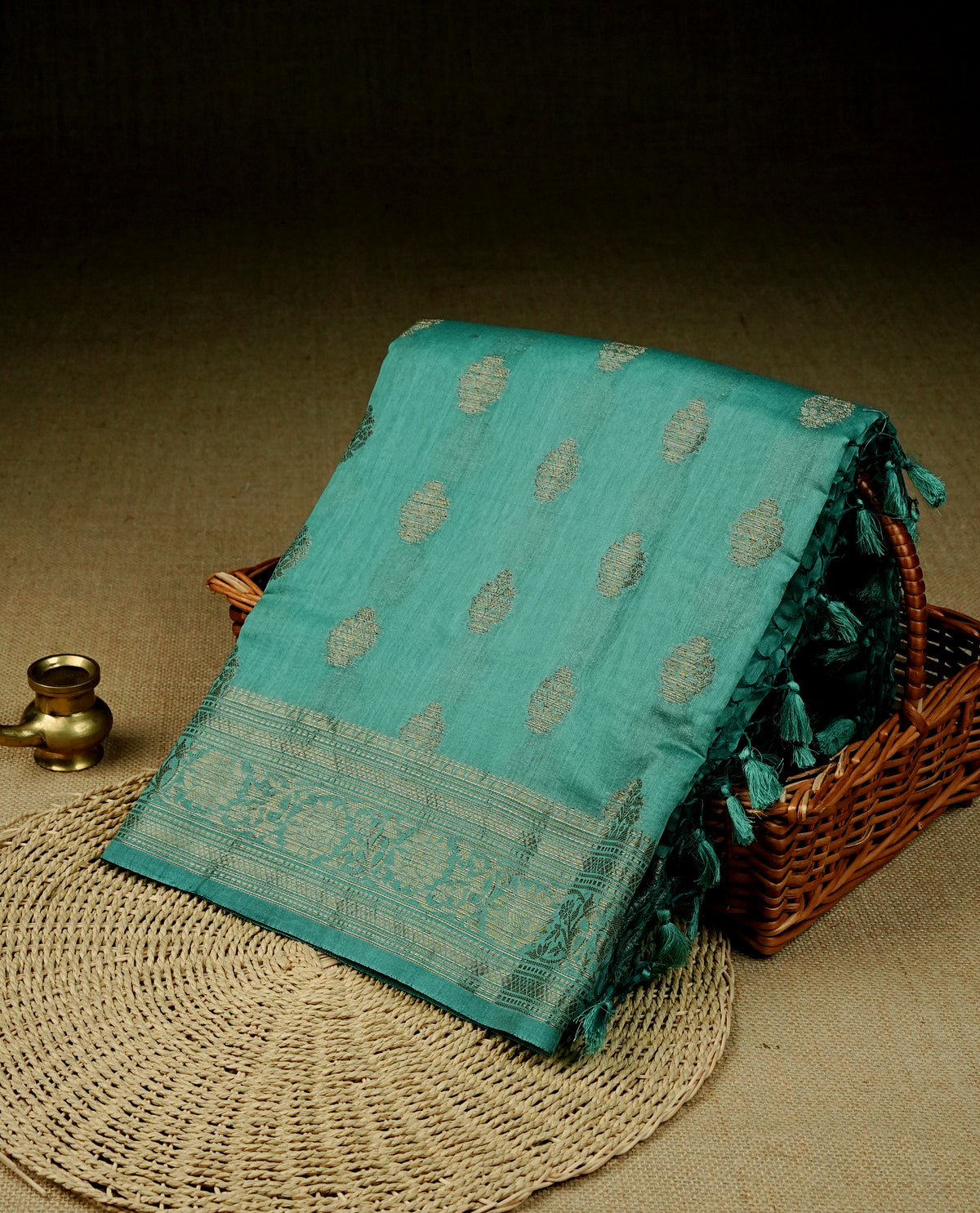Aqua colour Banaras silk saree featuring gold zari buttas on body, complemented by self colour with zari border, comes with matching blouse piece.