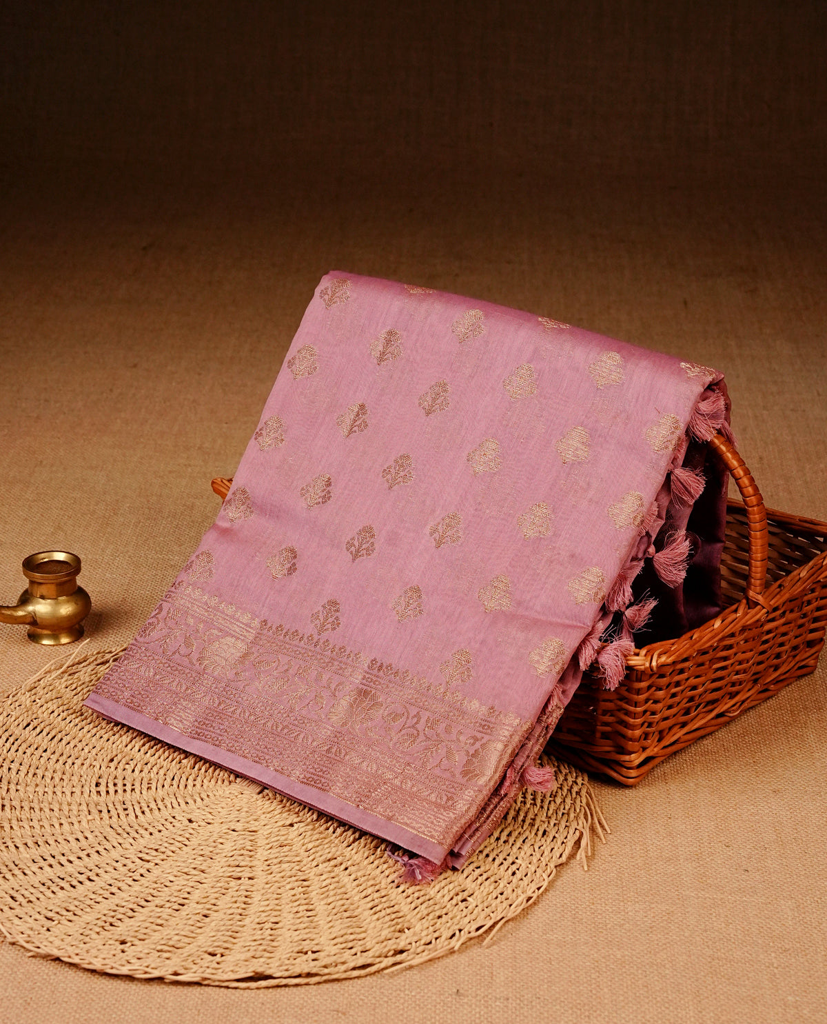 Pink colour Banaras silk saree featuring gold zari buttas on body, complemented by self colour with zari border, comes with matching blouse piece.