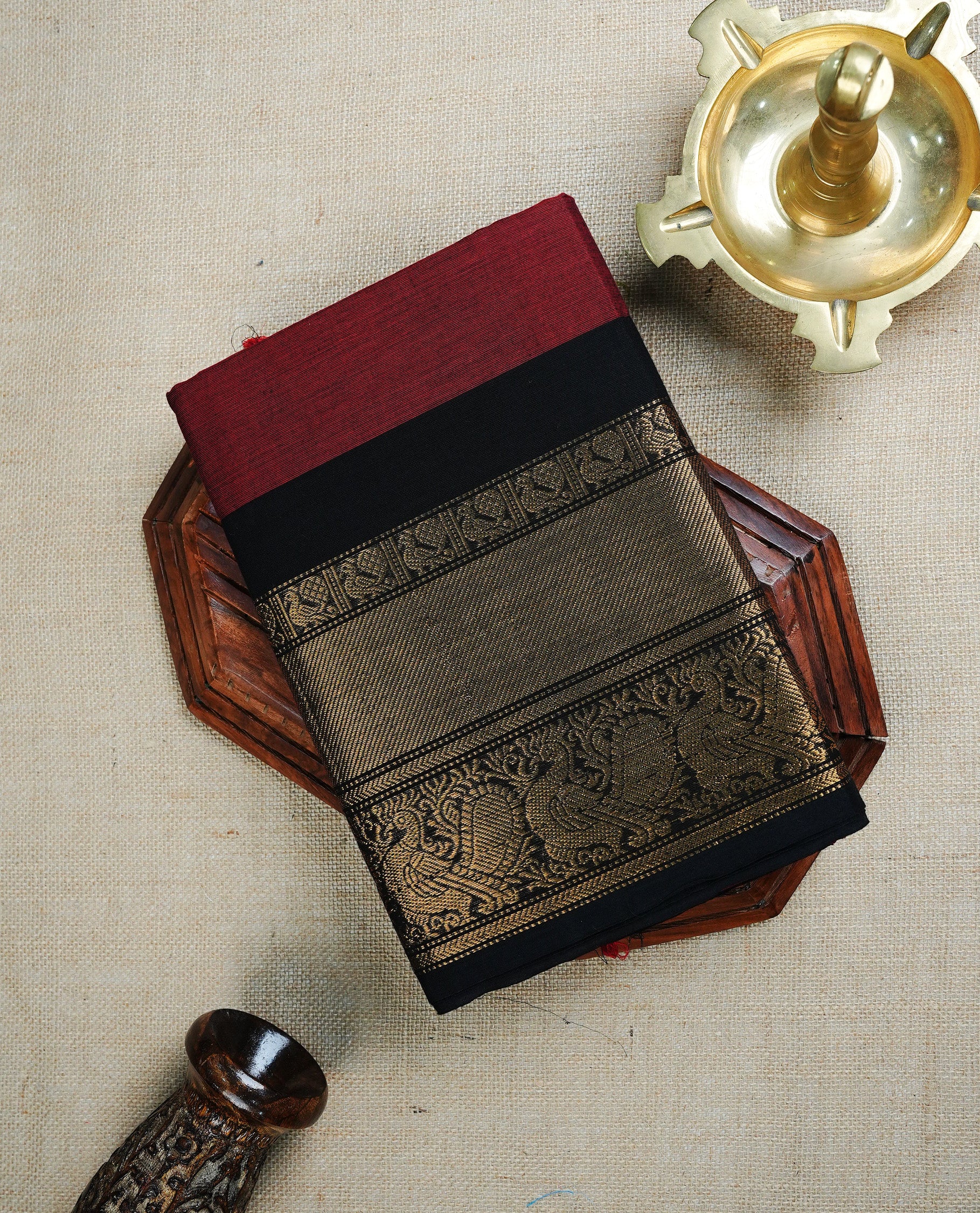 Maroon colour chettinad cotton saree featuring Elegant plain body , complemented by contrast Black colour with traditional Border, paired with matching blouse piece.