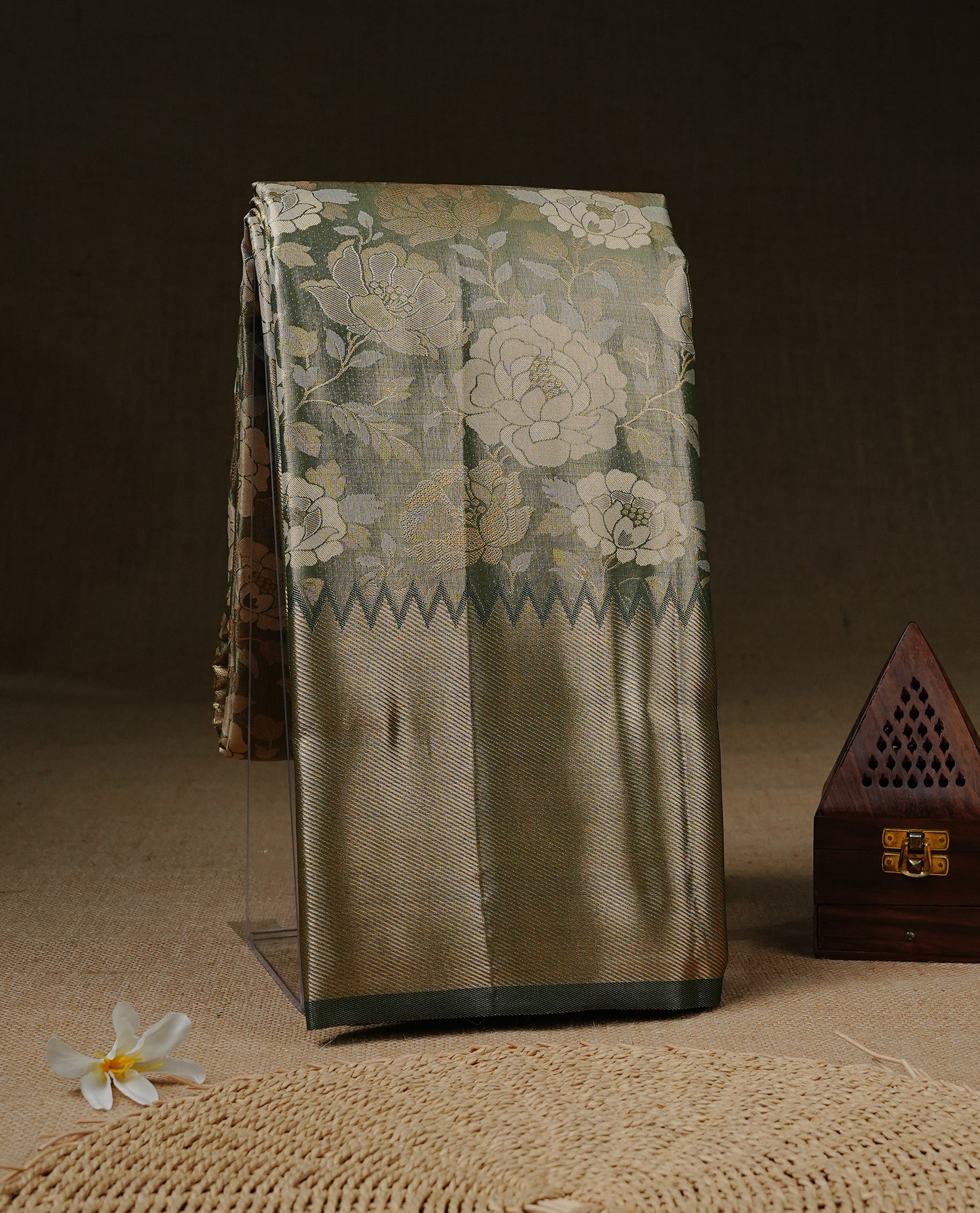 Light green colour Tissue silk saree featuring Gold & silver colour floral zari motifs on body, complemented by contrast Light green with gold zari border, paired with matching blouse piece.