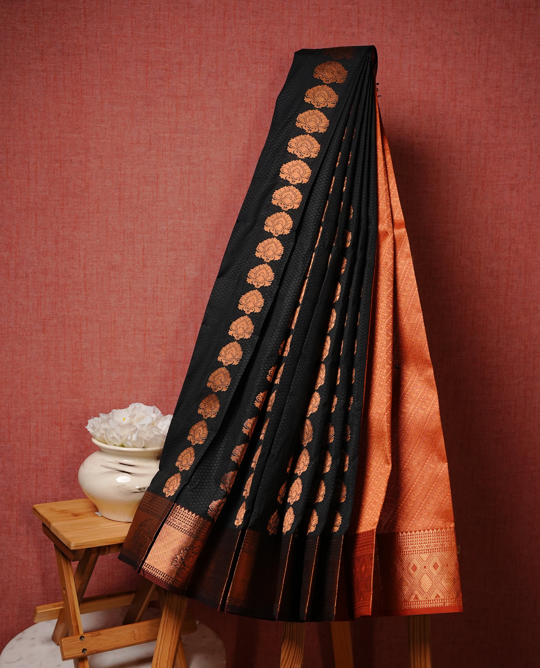 Black colour Semi silk saree Featuring gold zari motifs on body, complemented by contrast Brown colour with gold zari border, paired with matching blouse piece.