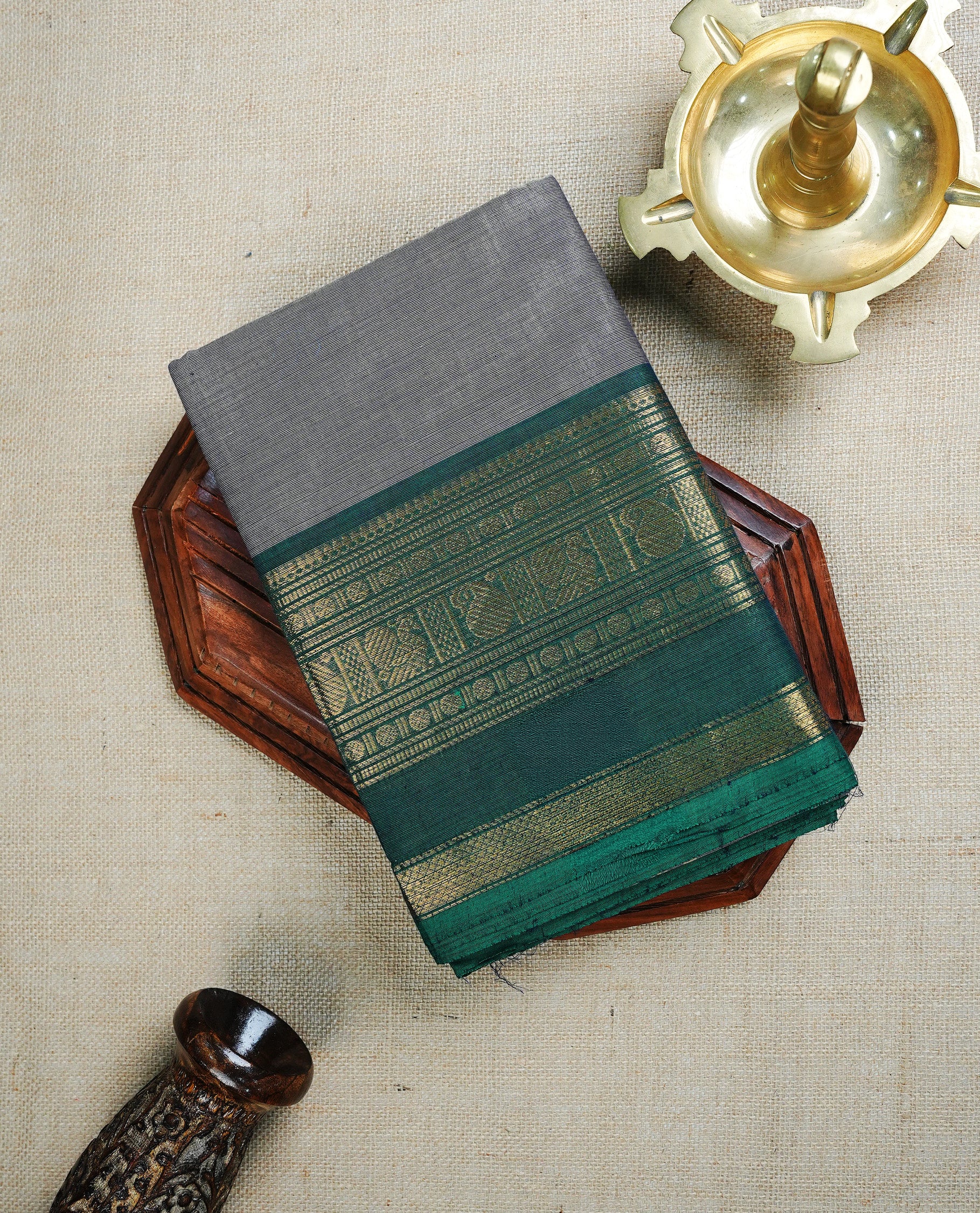 Grey colour chettinad cotton saree featuring Plain body, complemented by Green Colour With Gold Zari border, paired with matching blouse piece.