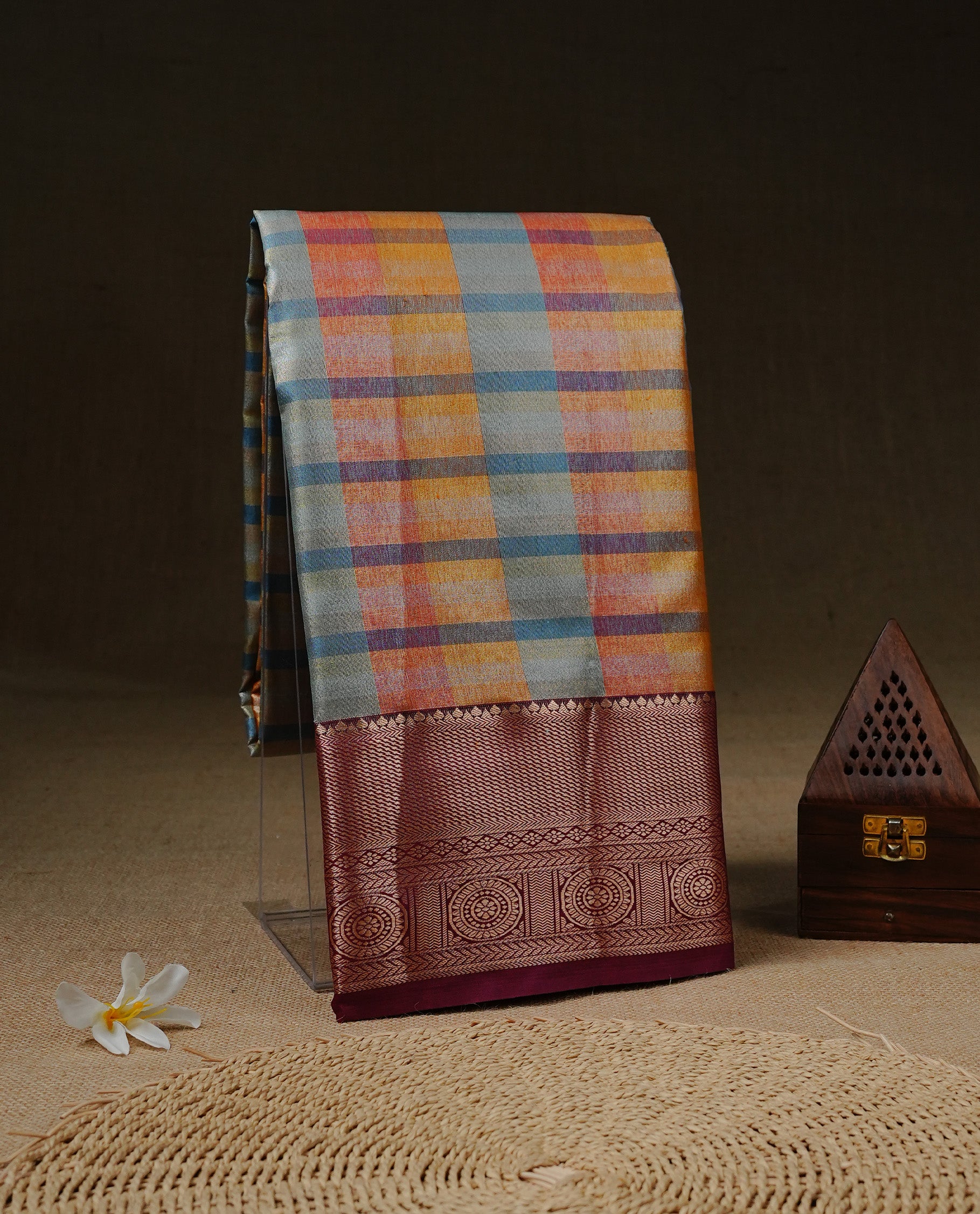 Blue, Red & Yellow Colour Tissue Saree featuring Multi colour Check Design on body, complemented by contrast Burgundy colour with Gold zari border, paired with matching blouse piece.