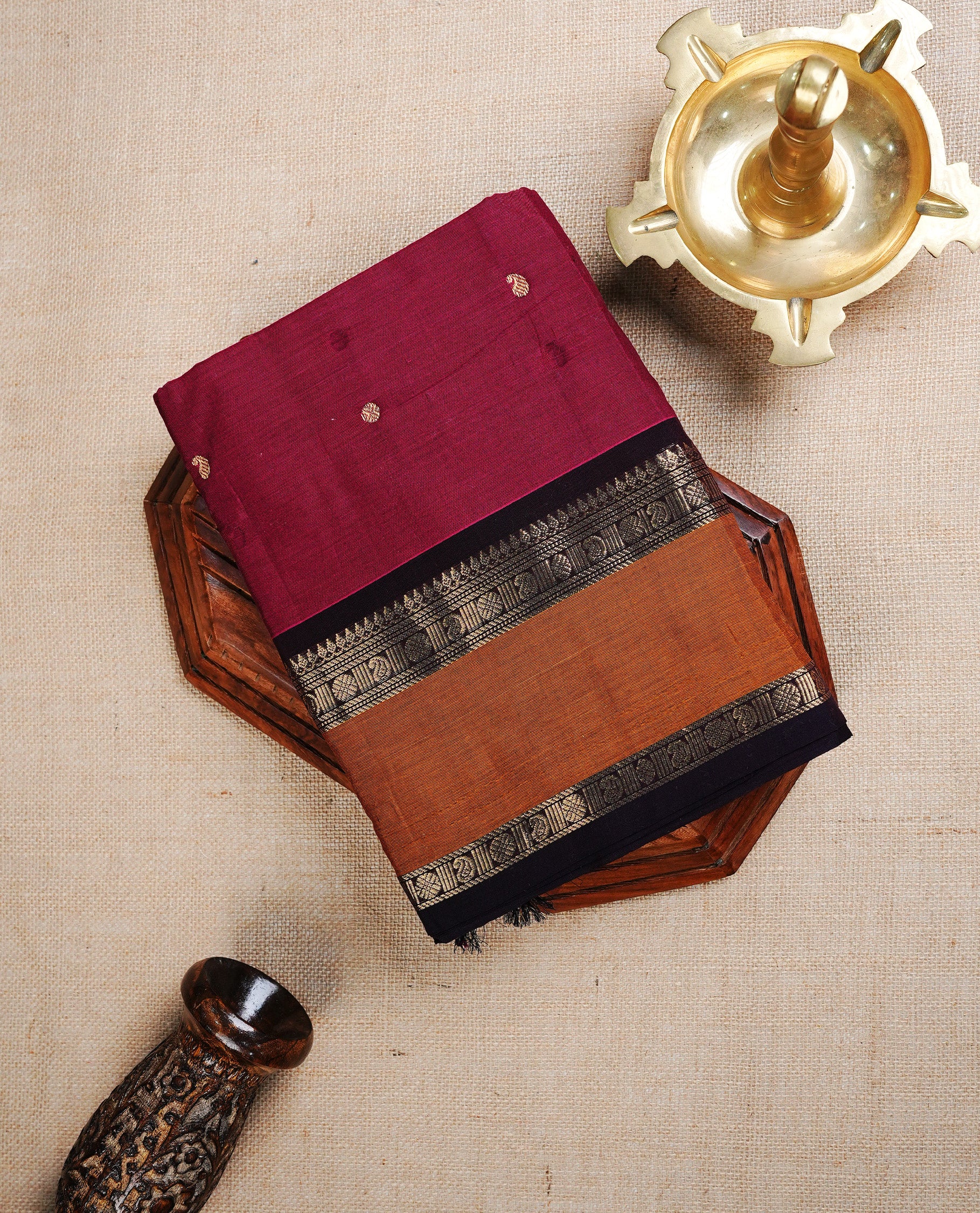 Dark Magenta colour chettinad cotton saree featuring Gold Motifs on body, complemented by Contrast Mustard Colour With Gold Zari border, paired with matching blouse piece.