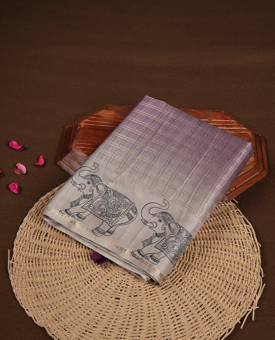 Light Purple colour semi tusser silk saree featuring Gold zari check pattern across body, faded contrast cream colour border with elephant print and paired with matching blouse.