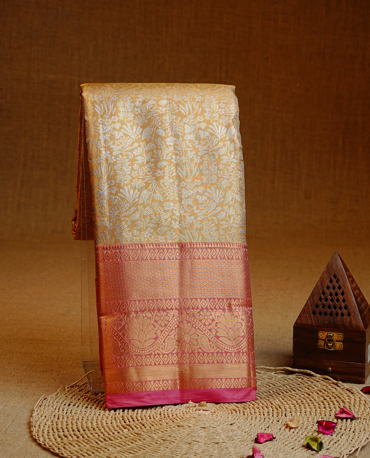 Gold colour Semi tissue silk saree featuring silver zari kodi floral motifs on body, Contrast Mauve colour with traditional border, paired with matching blouse piece.