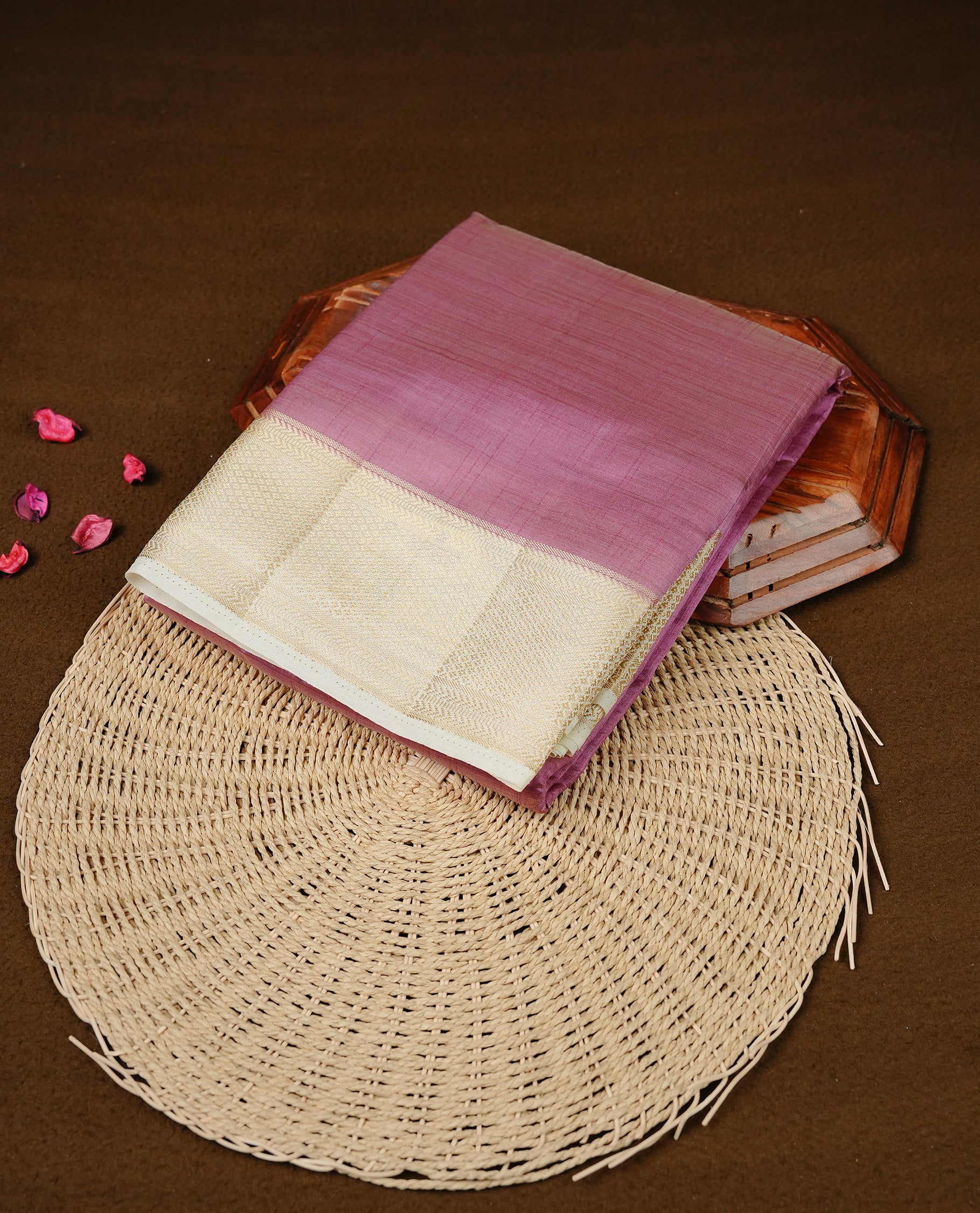 Purple colour Semi Tussar silk saree featuring an elegant plain body, accentuated by a contrast cream border adorned with intricate gold zari work, paired with a matching blouse piece.