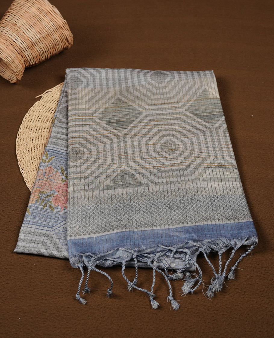 Green colour semi tussar silk saree, featuring subtle hexagonal geometric patterns across the body, a textured pallu with fine detailing, and finished with a matching blouse.