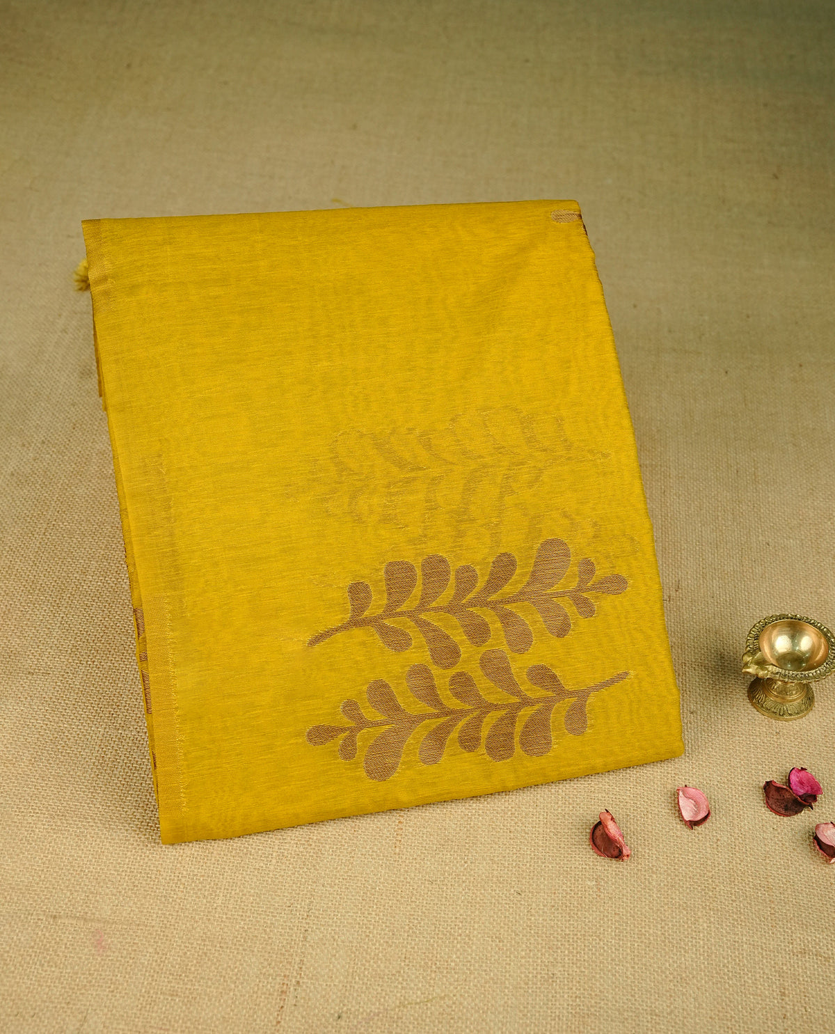 Mustard colour semi linen saree with elegant gold zari Leaf motifs across the body, complemented by a contrast colour with grand gold zari pallu and a borderless design, paired with a matching blouse piece.