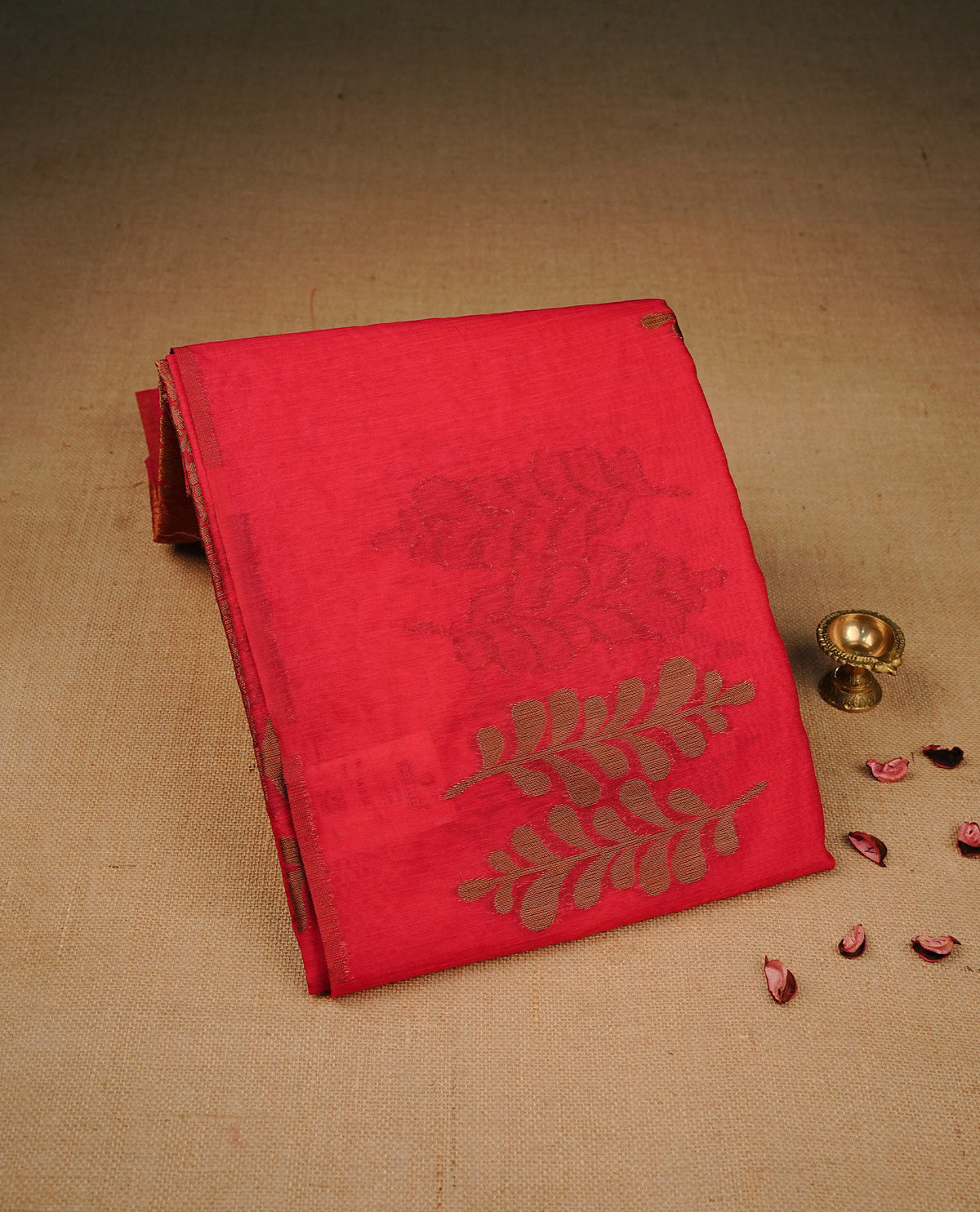 Rani Pink colour semi linen saree with elegant gold zari Leaf motifs across the body, complemented by a contrast colour with grand gold zari pallu and a borderless design, paired with a matching blouse piece.