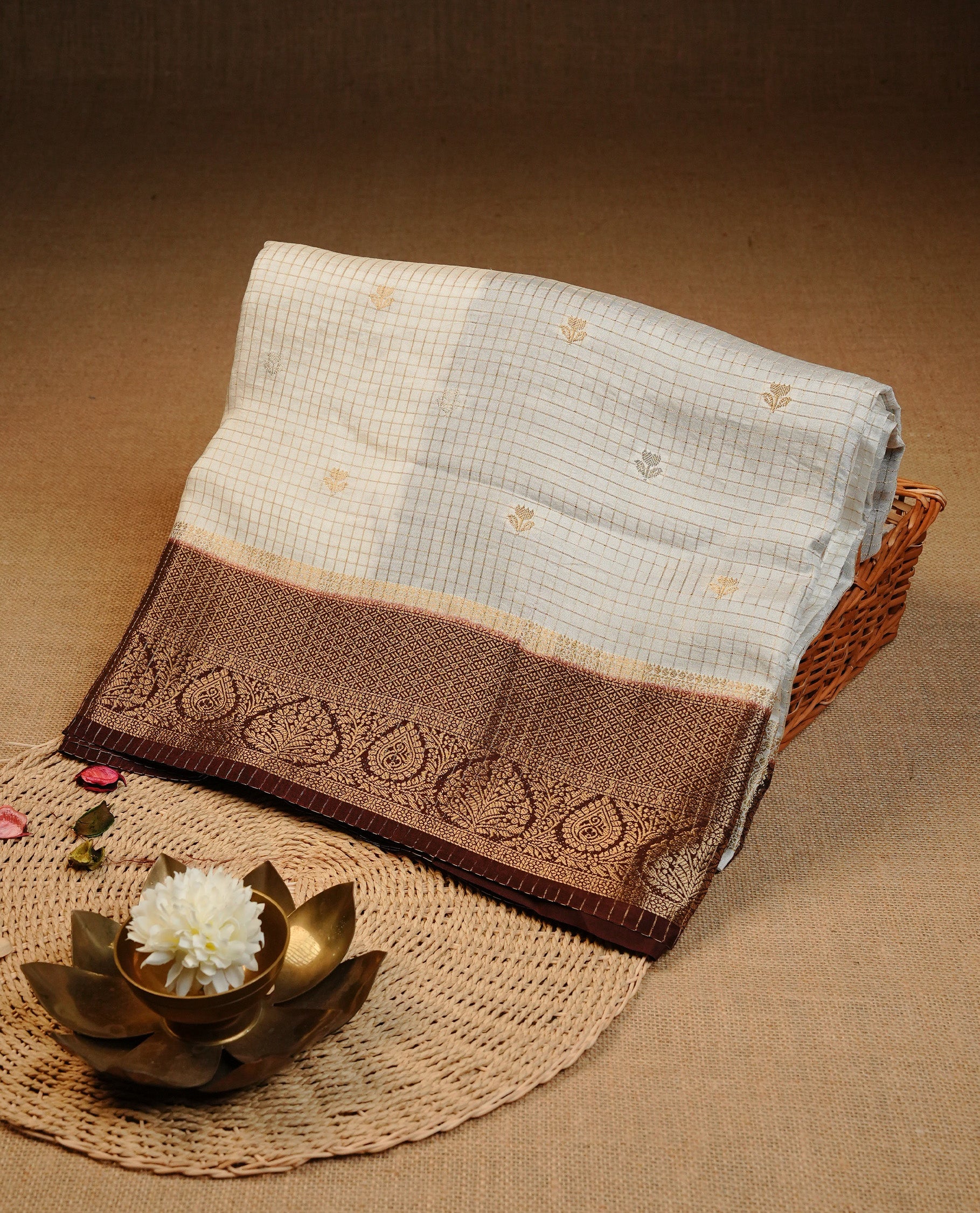 Semi Banaras Tussar Saree Featuring Gold Zari Check With Floral Pattern On Body , Chocolate Brown Colour With Gold Zari Border , Paired With A Matching Blouse Piece.
