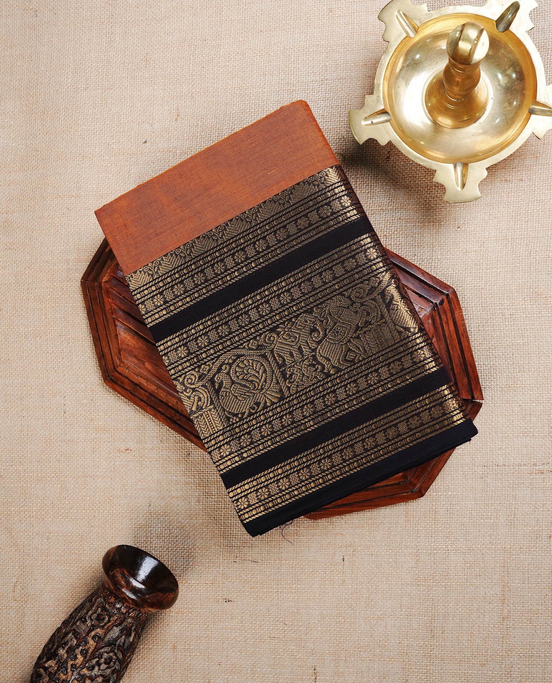 Mustard Orange colour chettinad cotton saree featuring Plain body, complemented by Contrast Dark Chocolate Colour With Traditional Gold Zari border, paired with matching blouse piece.
