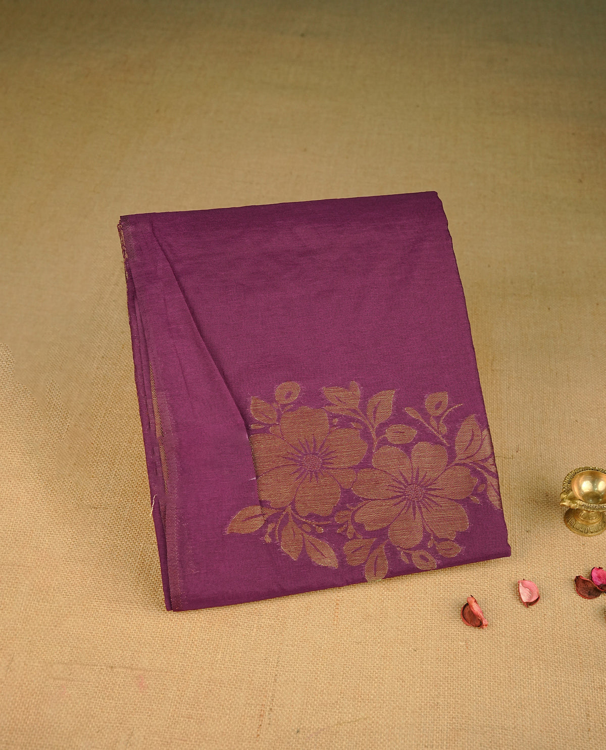 Deep Purple colour semi linen saree with elegant gold zari floral motifs across the body, complemented by a contrast colour with grand gold zari pallu and a borderless design, paired with a matching blouse piece.