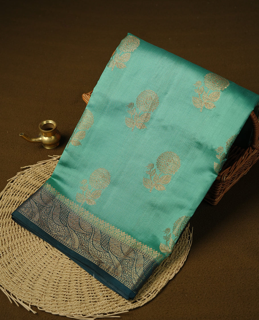 Aqua Green colour Pure tussar Banarasi saree featuring Gold zari motifs on body, a contrast Teal colour gold zari border, and blouse piece.