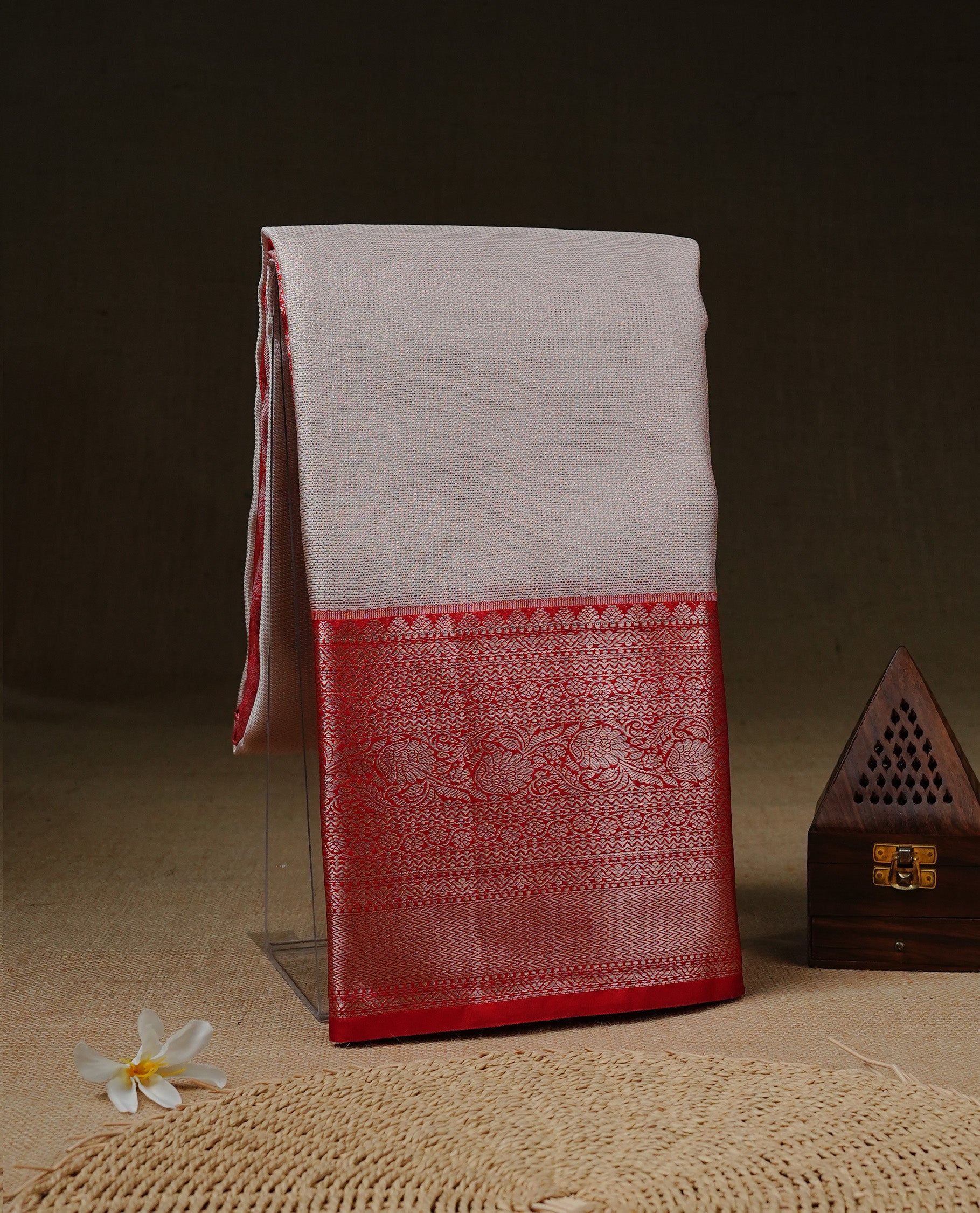 Light pinkish Cream colour Net Tissue saree Elegant plain body, complemented by Red colour with Light gold zari traditional border, paired with matching blouse piece.