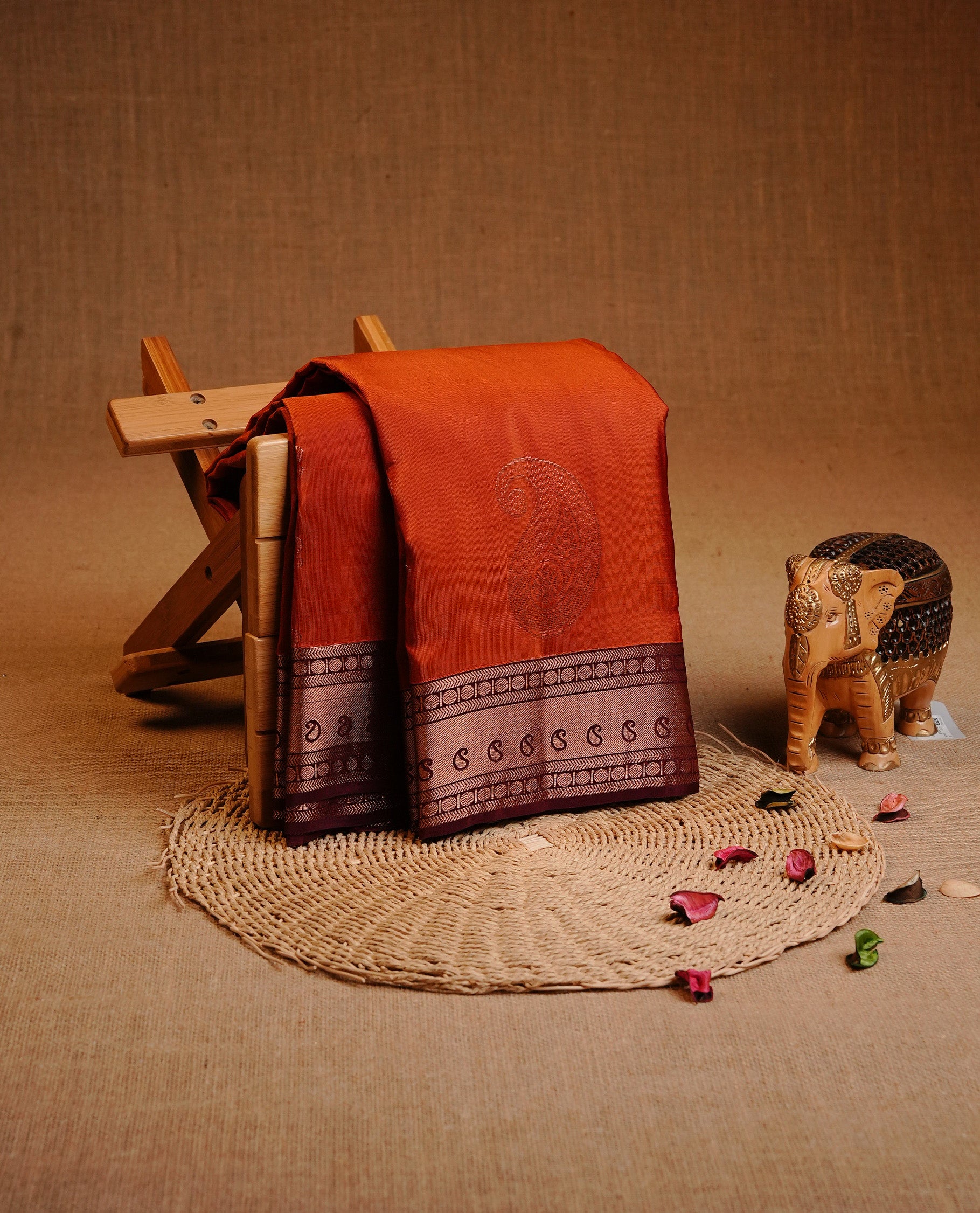 Dark Orange Colour Traditional Kancheepuram Slik Saree Featuring Gold Zari Mango Motifs on the Body, Complemented by a Contrast Maroon Colour Gold Zari Traditional Border and Pallu, Paired with a Matching Blouse .