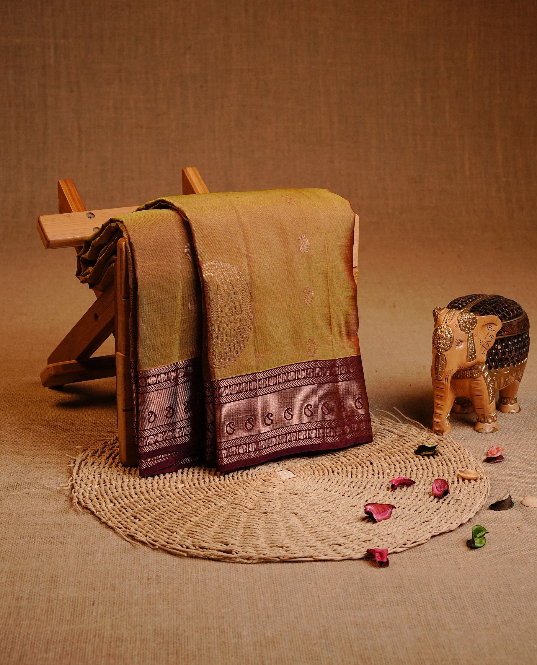 Olive Colour Traditional Kancheepuram Silk Saree Featuring Gold Zari Mango Motifs on the Body, Complemented by a Contrast Maroon Colour Gold Traditional Border and Pallu, Paired with a Matching Blouse .