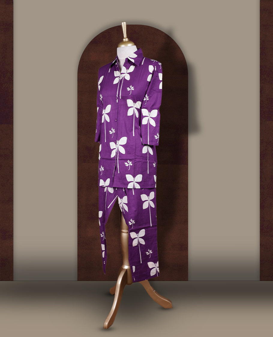 Dark purple colour cord set with bold off white floral prints,Features a collared kurta with front buttons and 3/4 sleeves, paired with matching pants for a trendy and contemporary ethnic look.