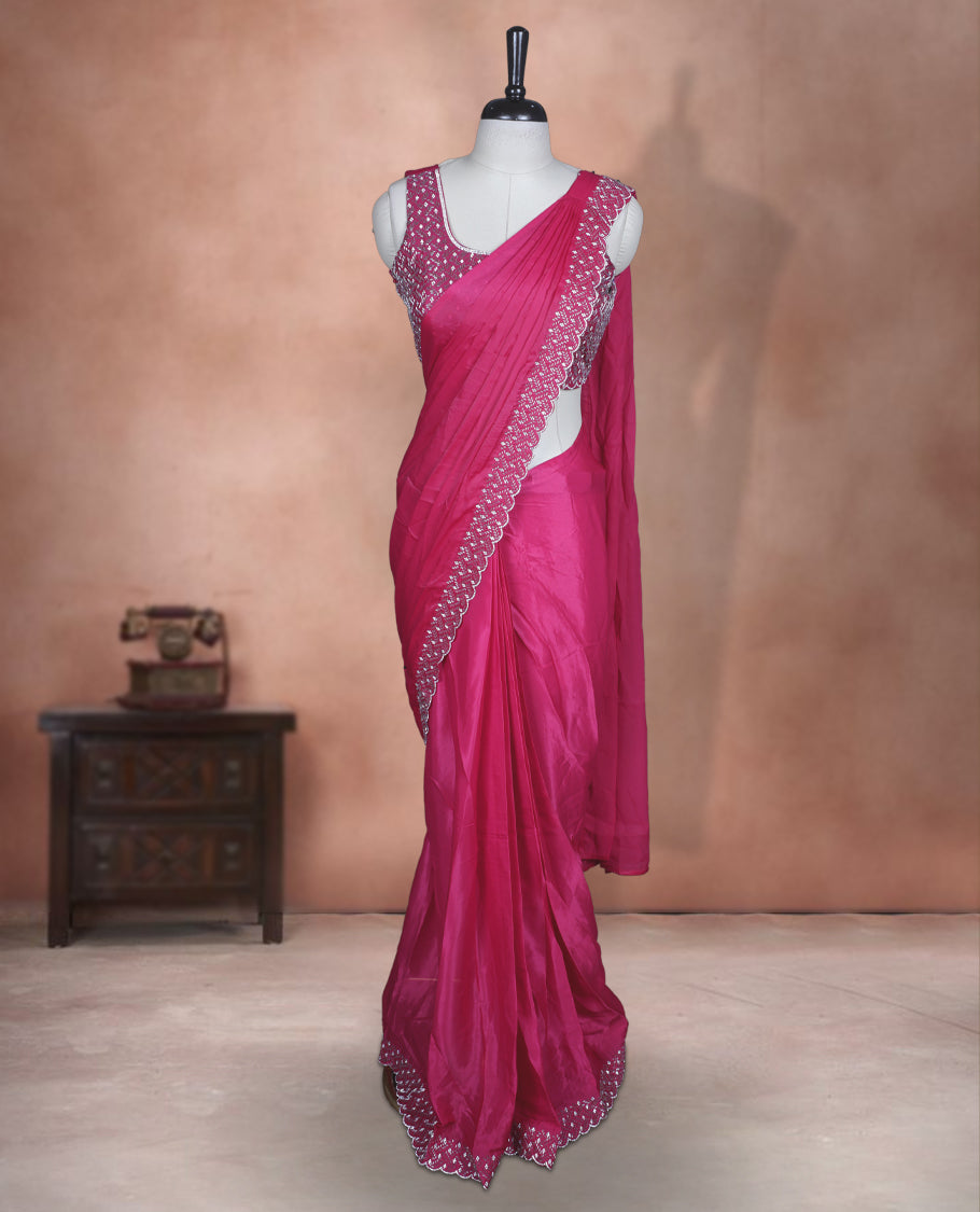 Elegant Rani pink Colour ready to wear saree adorned with rich silver stone and bead embroidery along the border and pallu, paired with a heavily embellished matching blouse for a grand festive look.
