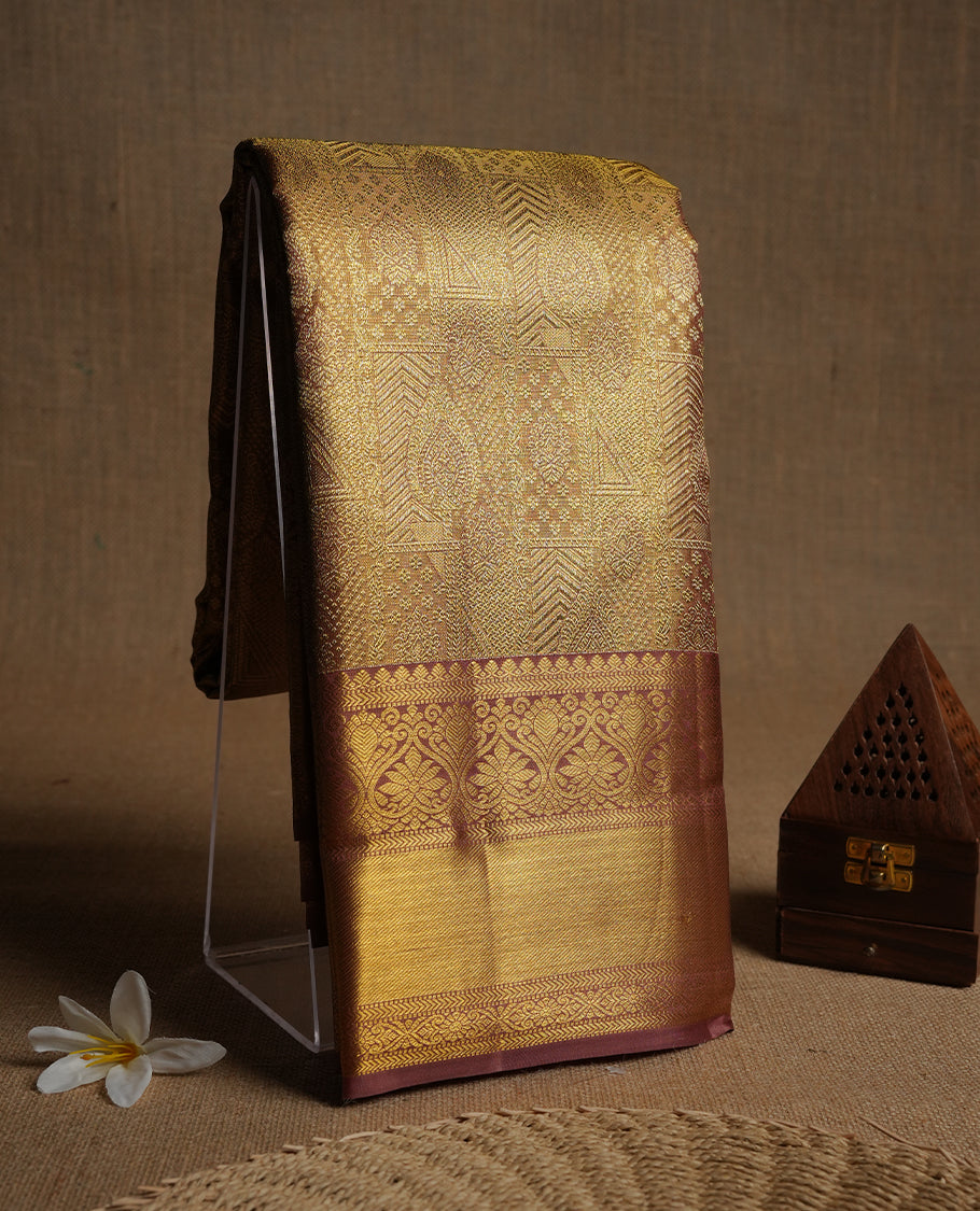 Brown & gold double shade colour kancheepuram tissue silk saree highlighting gold zari pattern body, with contrast Muted brwon colour colour with traditional border and paired with matching blouse.