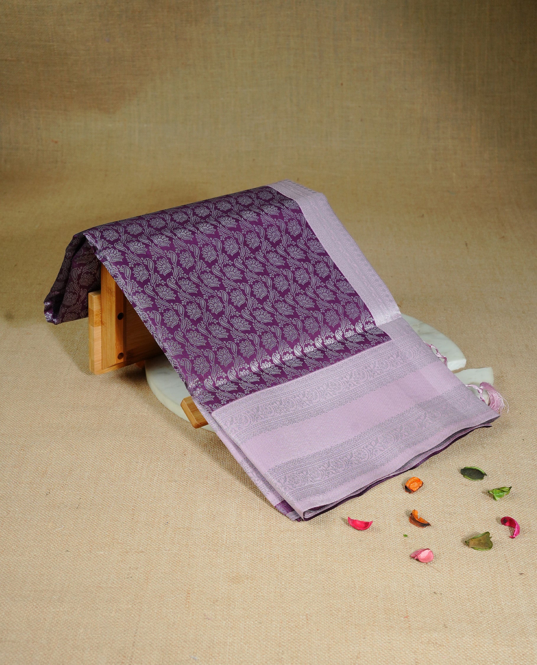 Purple colour semi silk saree featuring Silver zari Floral pattern on body, complemented by contrast Pink colour with silver zari border, comes with matching blouse piece.