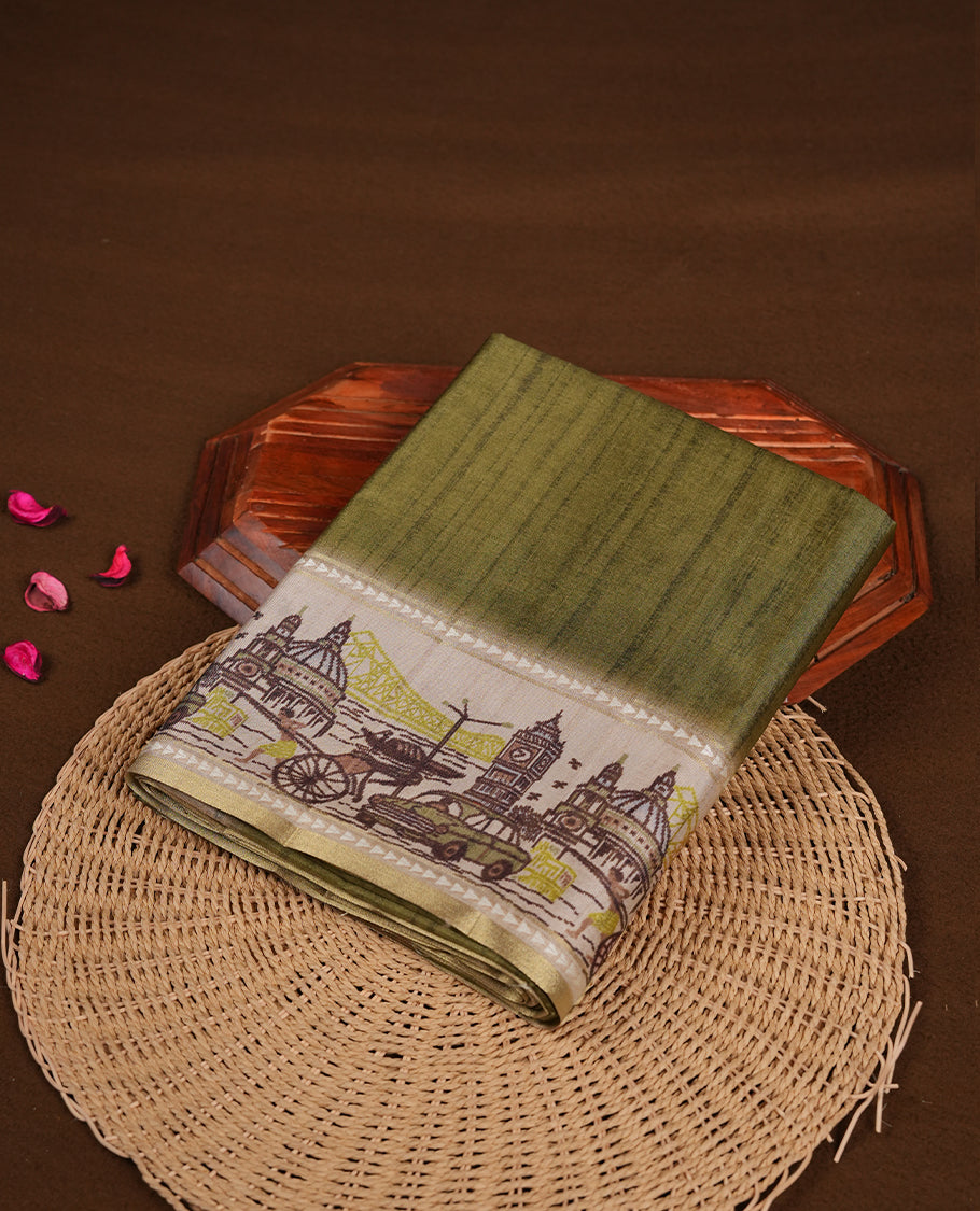 Green colour semi tusser silk saree featuring contrast cream colour London bridge printed pattern border and paired with matching blouse.