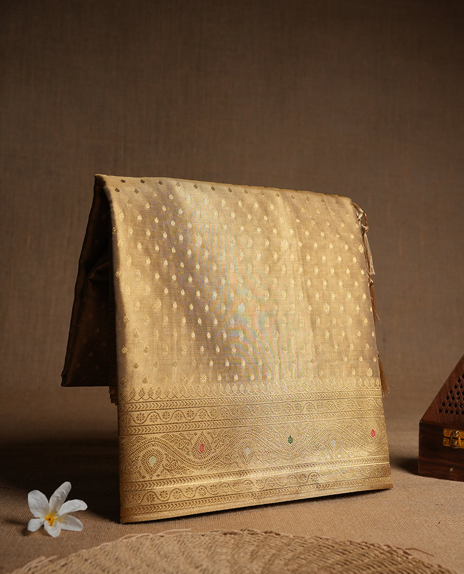 Antique gold colour tissue banaras silk saree featuring antique gold zari motifs on the body with rich traditional zari border and pallu, paired with a matching blouse piece.