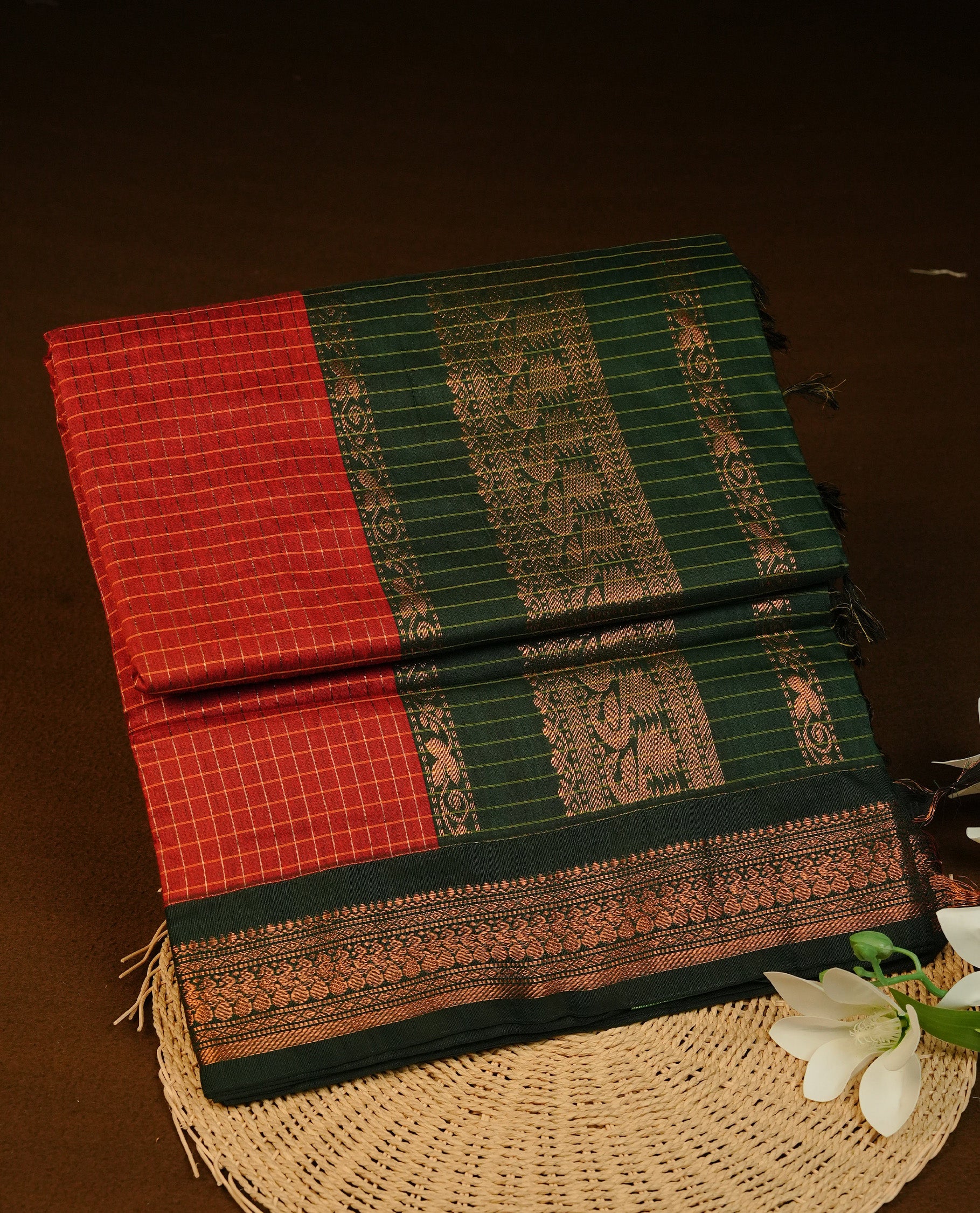 Maroon colour Kalyani cotton saree featuring Gold zari check pattern on body, complemented by Contrast Green colour with grand gold zari border & pallu, matching blouse piece
