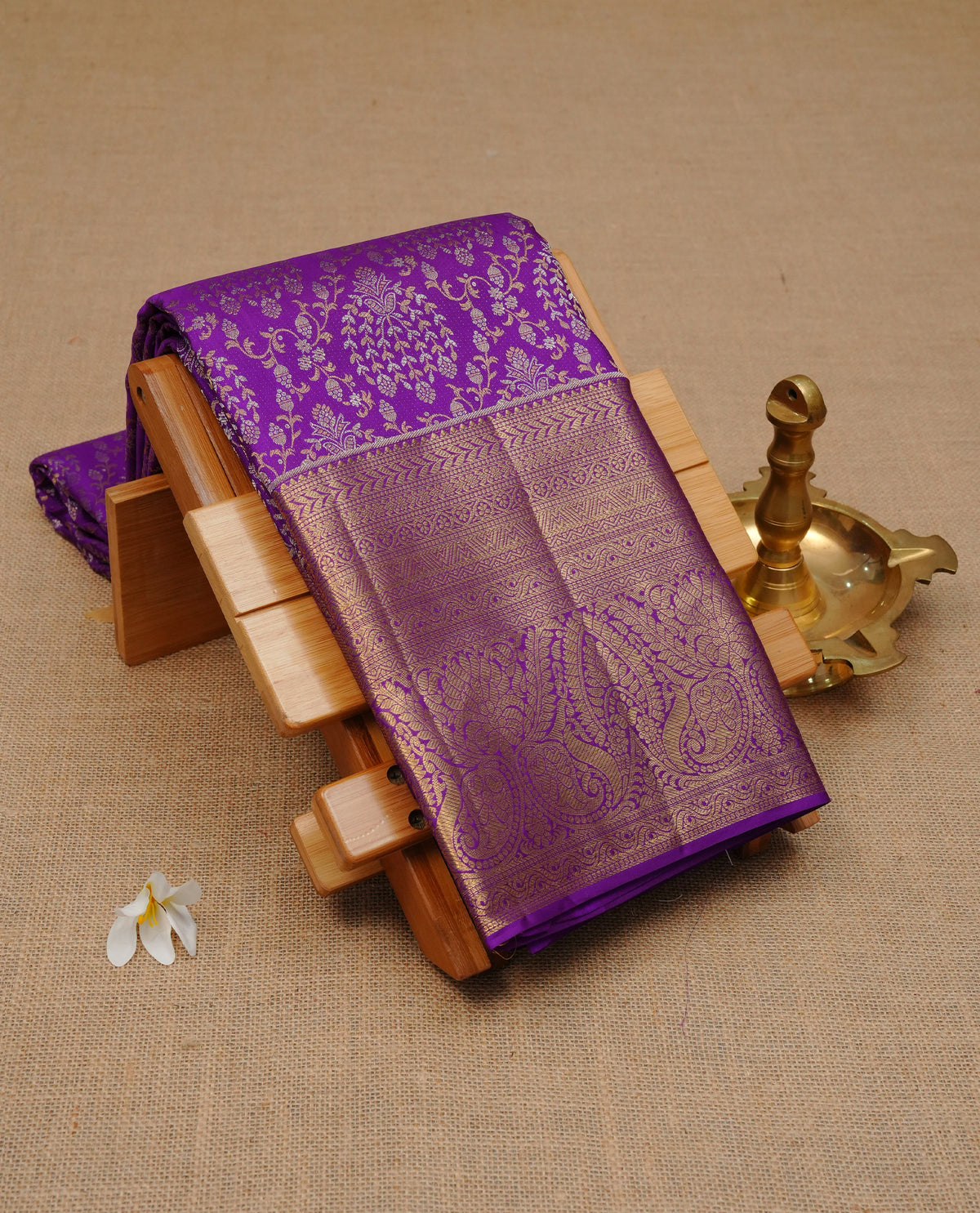 Violet colour pure wedding silk saree featuring silver & gold zari Designed pattern on body, complemented by self colour with traditional border, comes with matching blouse piece.
