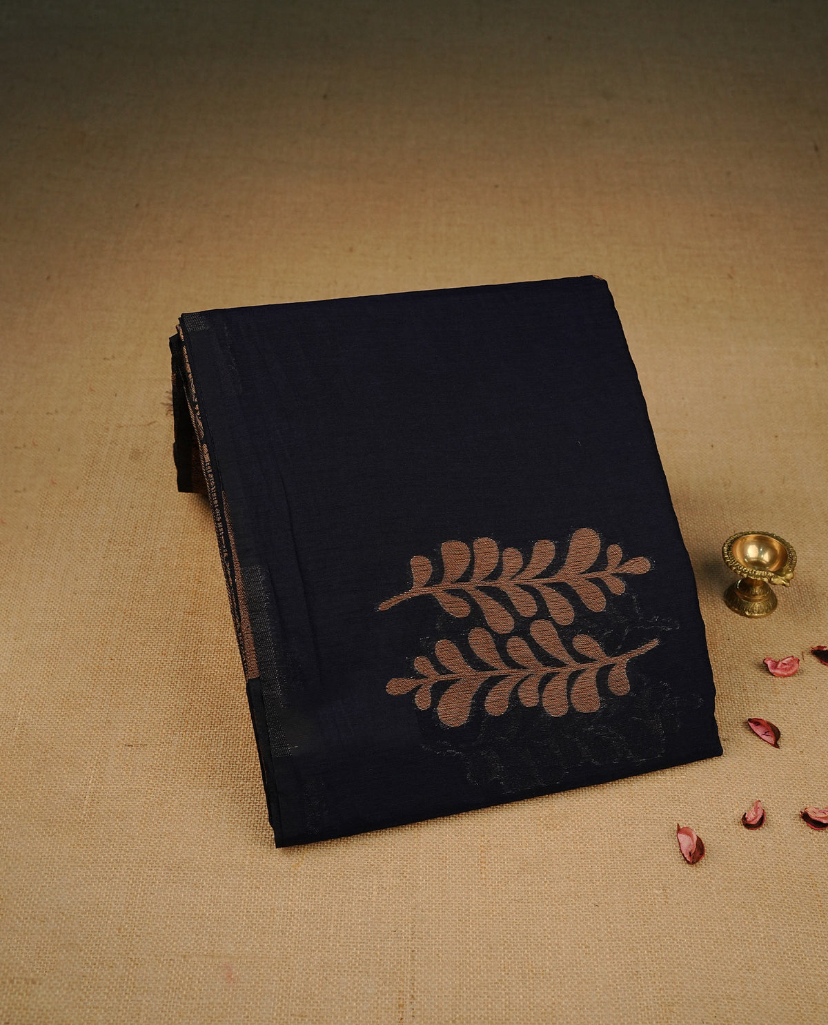 Navy blue colour semi linen saree with elegant gold zari Leaf motifs across the body, complemented by a contrast colour with grand gold zari pallu and a borderless design, paired with a matching blouse piece.