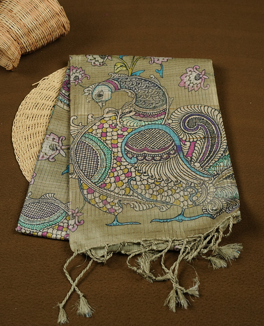 Olive Green colour semi tussar silk saree, featuring an intricate multicolour peacock motif on the pallu, a subtle self-textured plain body, and a floral-printed matching blouse.