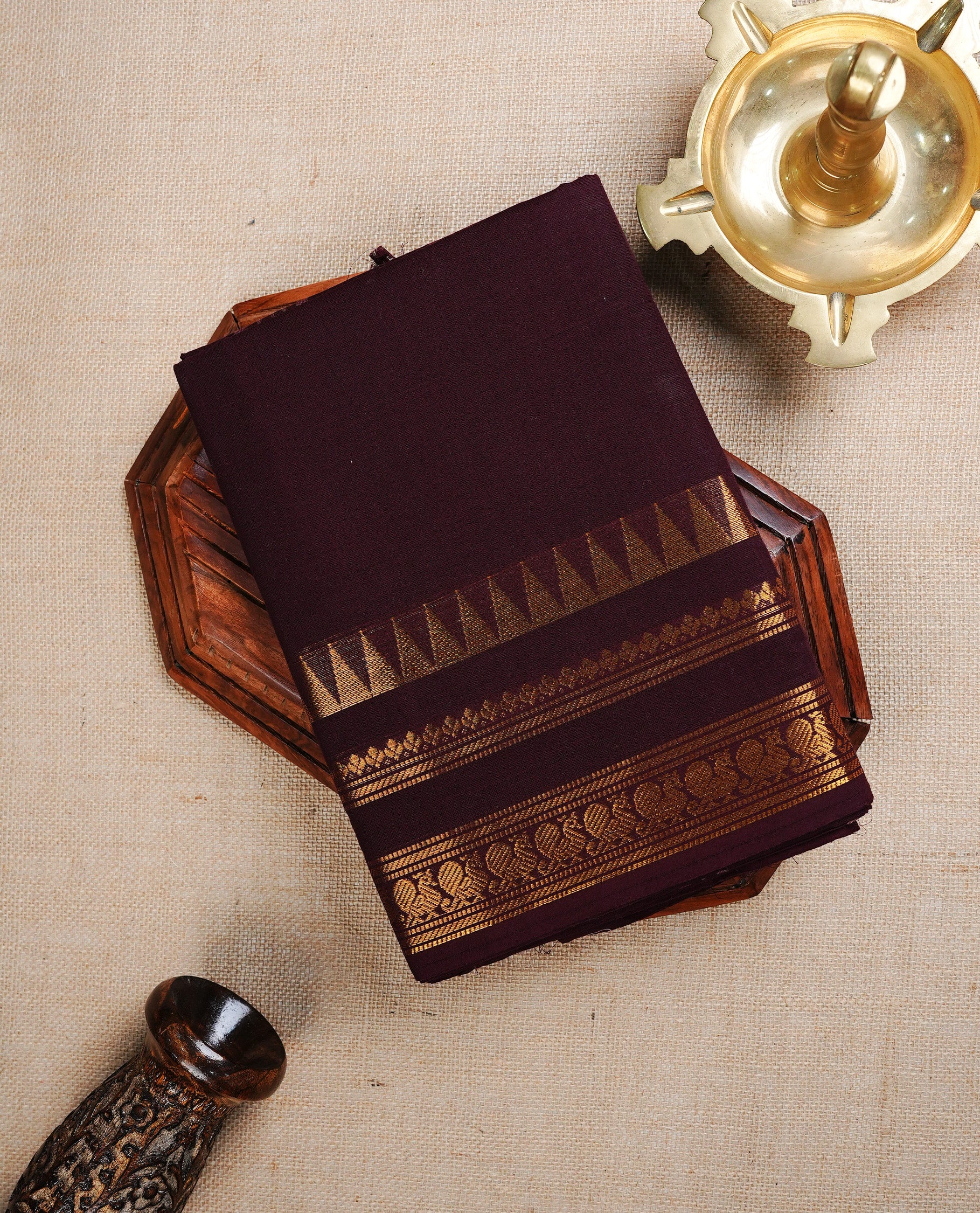 Dark chocolate Colour chettinad cotton saree featuring Elegant plain body, complemented by self colour with Gold zari border, paired with matching blouse piece.