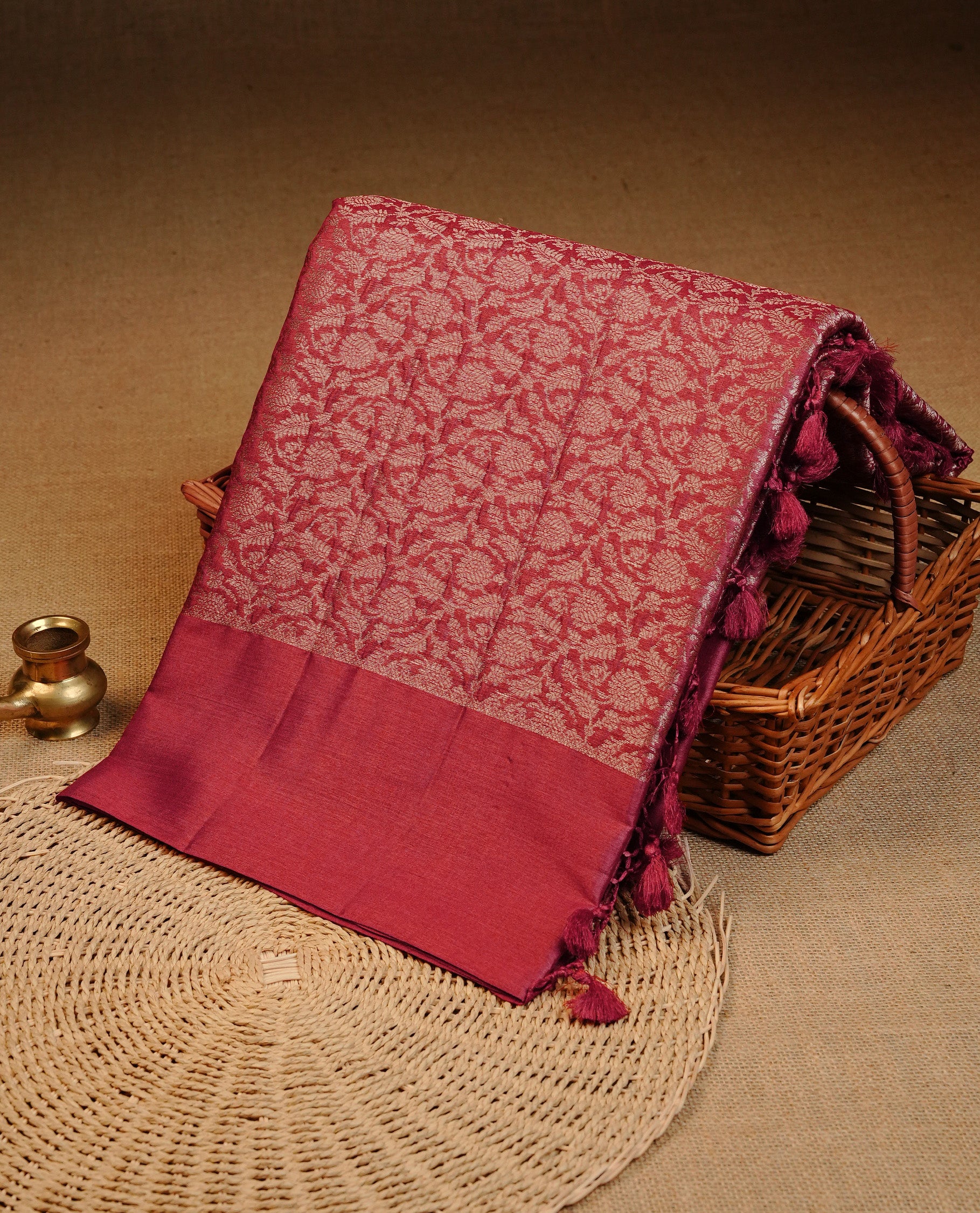 Red colour pure tussar silk saree featuring light gold zari floral kodi work on the body, a plain border & grand pallu, Paired With a matching blouse piece.
