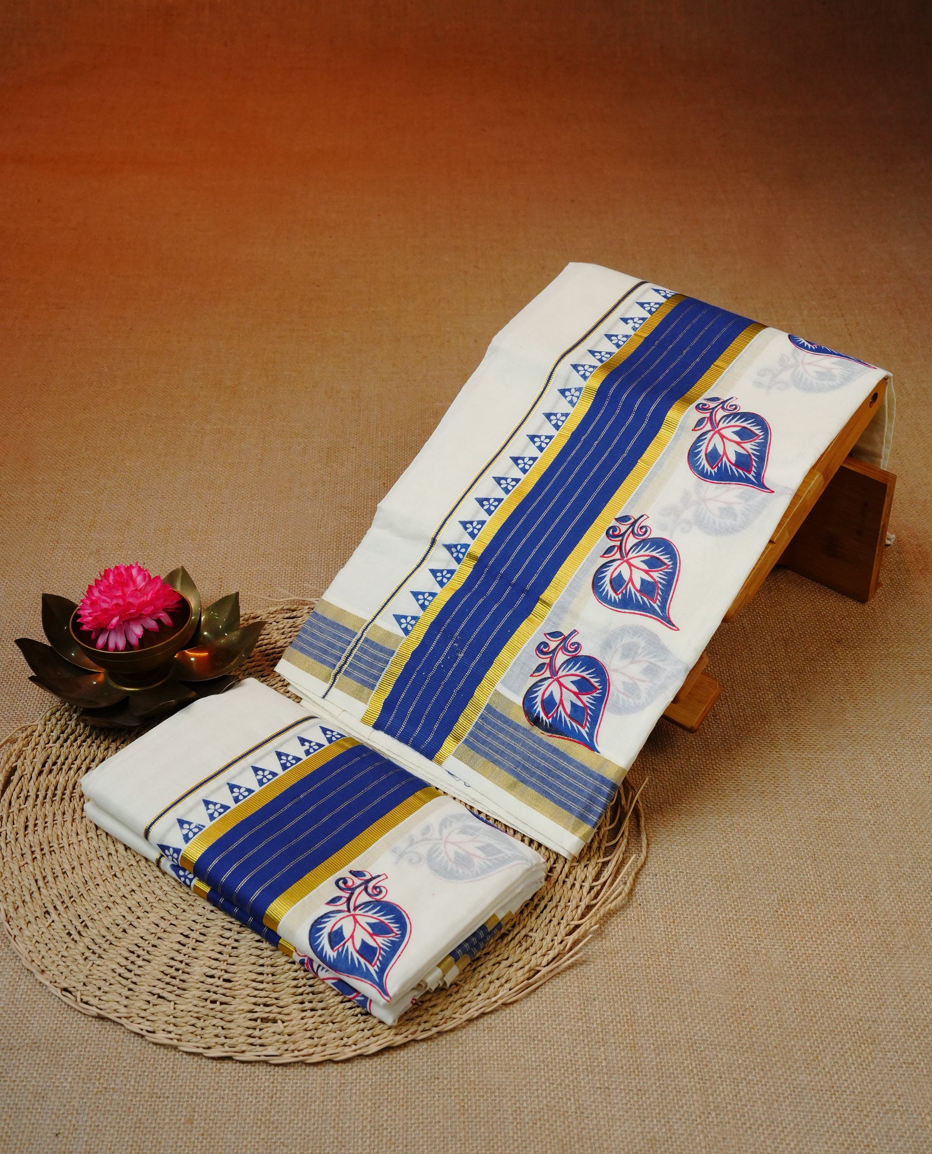 Cream colour cotton set mundu featuring Kasavu with blue kara with temple print.