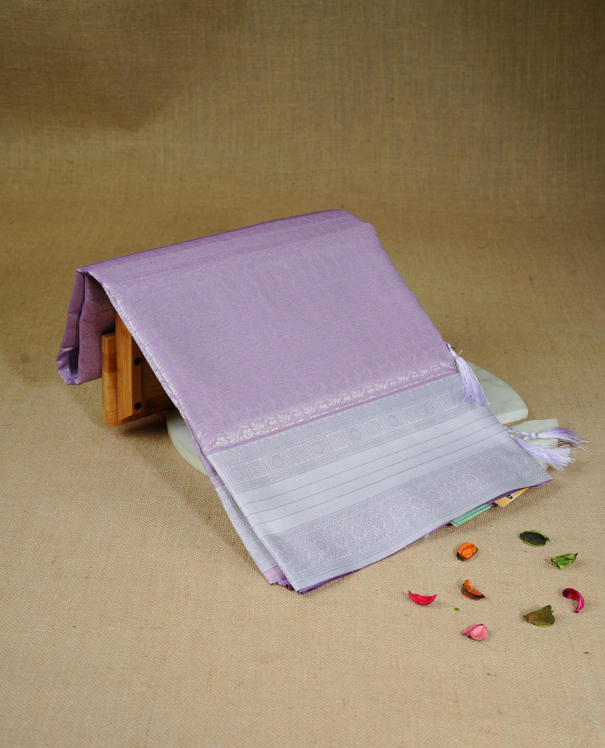 Pink colour semi silk saree featuring Silver zari Floral pattern on body, complemented by contrast lavender colour with silver zari border, comes with matching blouse piece.