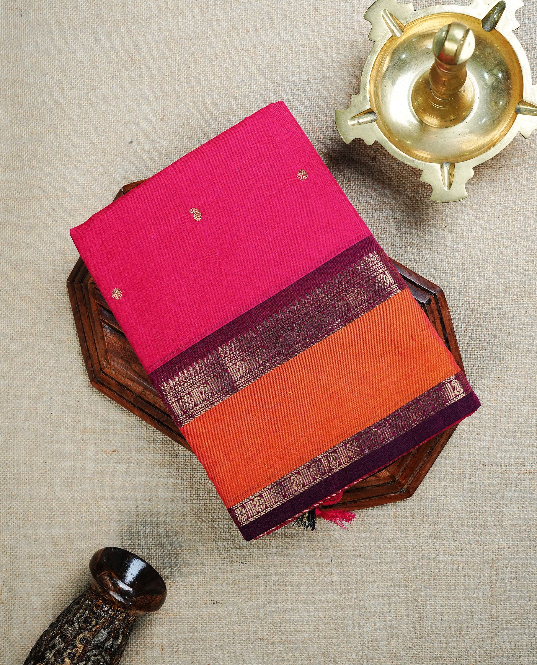 Rani Pink colour chettinad cotton saree featuring Gold Motifs on body, complemented by Contrast Rust Orange & Maroon Colour With Gold Zari border, paired with matching blouse piece.