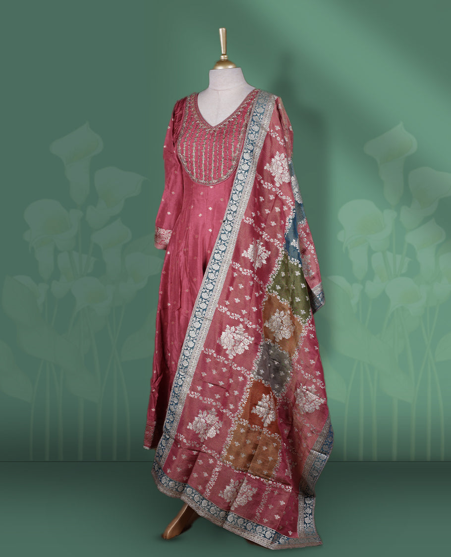 Dark Mauve colour Anarkali Suit with V neck embellished with cut beads, pearls, and sequins, Paired with a vibrant Banarasi dupatta featuring floral motifs and zari border & Comes with a plain matching bottom.