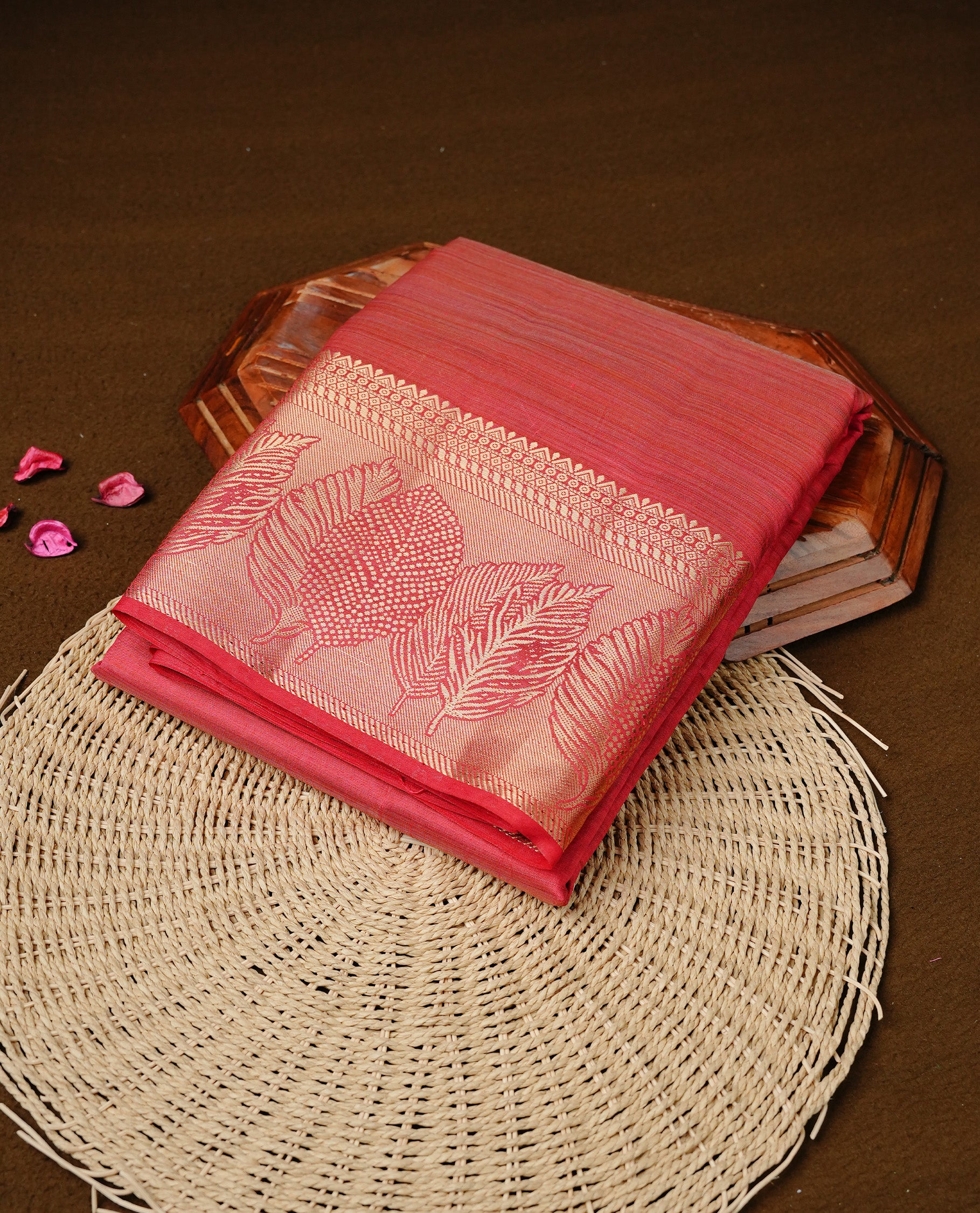 Red colour semi tussar silk saree featuring an elegant plain body with traditional gold zari detailed border for a refined look. Comes paired with a matching blouse piece.