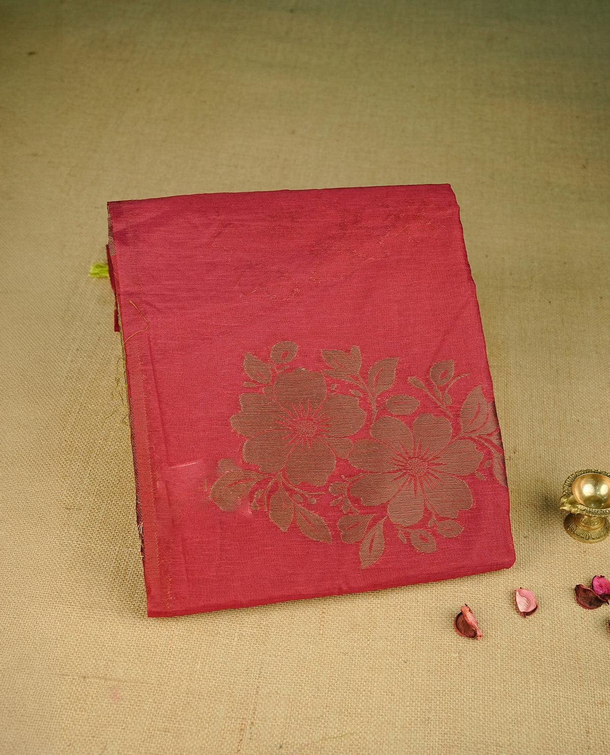 Maroon colour semi linen saree with elegant gold zari floral motifs across the body, complemented by a contrast green colour with grand gold zari pallu and a borderless design, paired with a matching blouse piece.