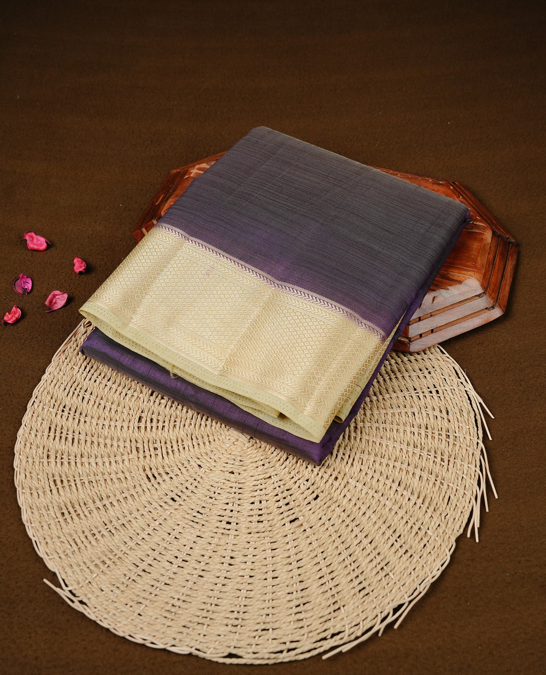 Deep Purple colour Semi Tussar silk saree featuring an elegant plain body, accentuated by a contrast cream border adorned with intricate gold zari work, paired with a matching blouse piece.