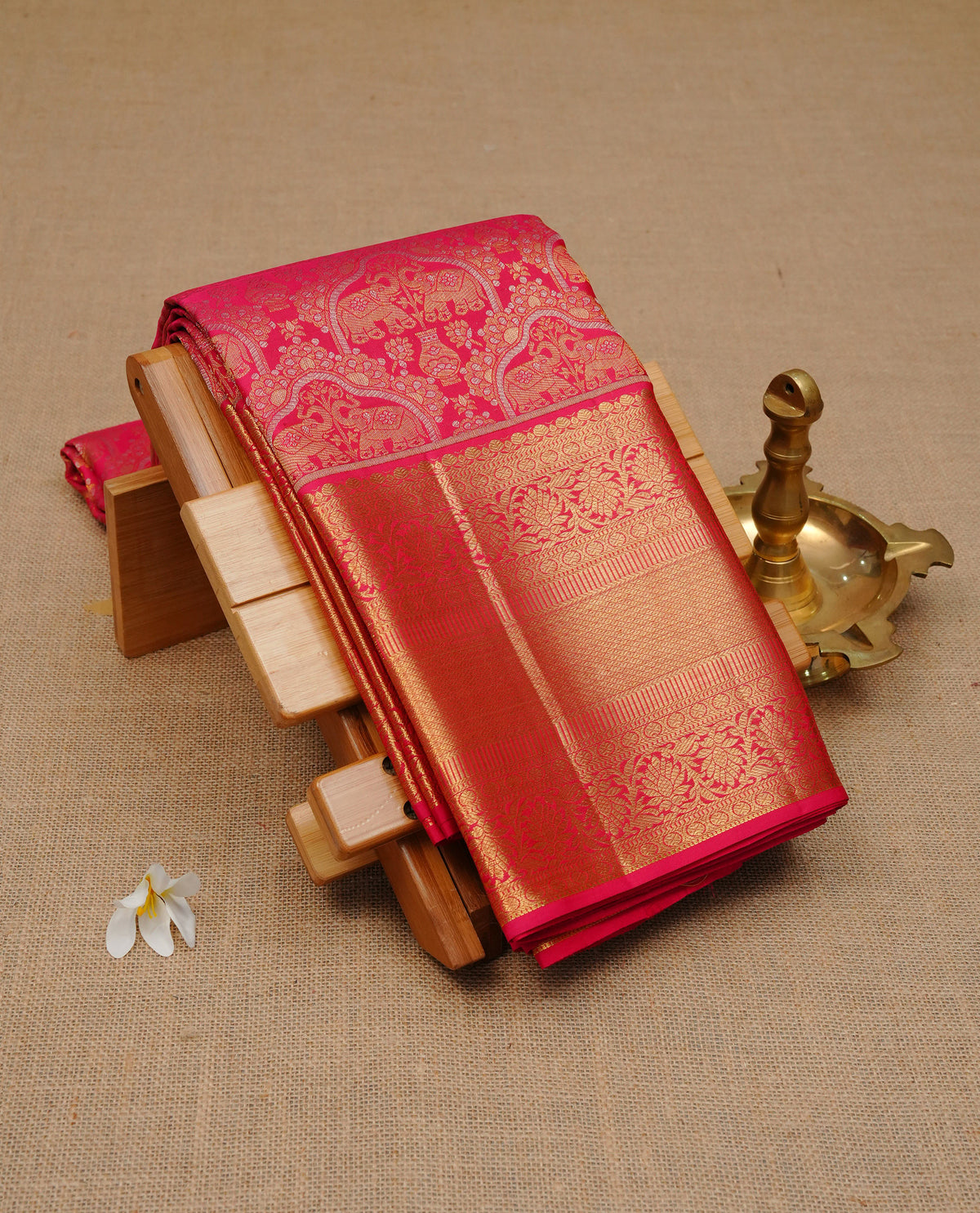 Magenta colour pure wedding silk saree featuring Gold & silver combined zari elephant pattern on body, complemented by self colour with traditional border, comes with matching blouse piece.
